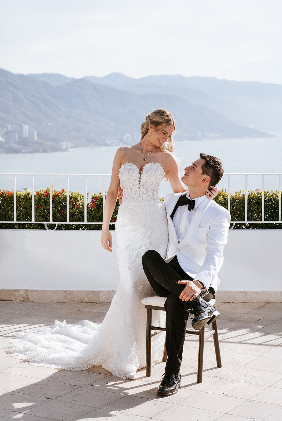 Bride and groom on a terrace overlooking the ocean in Puerto Vallarta, captured by José Carrillo Photography.