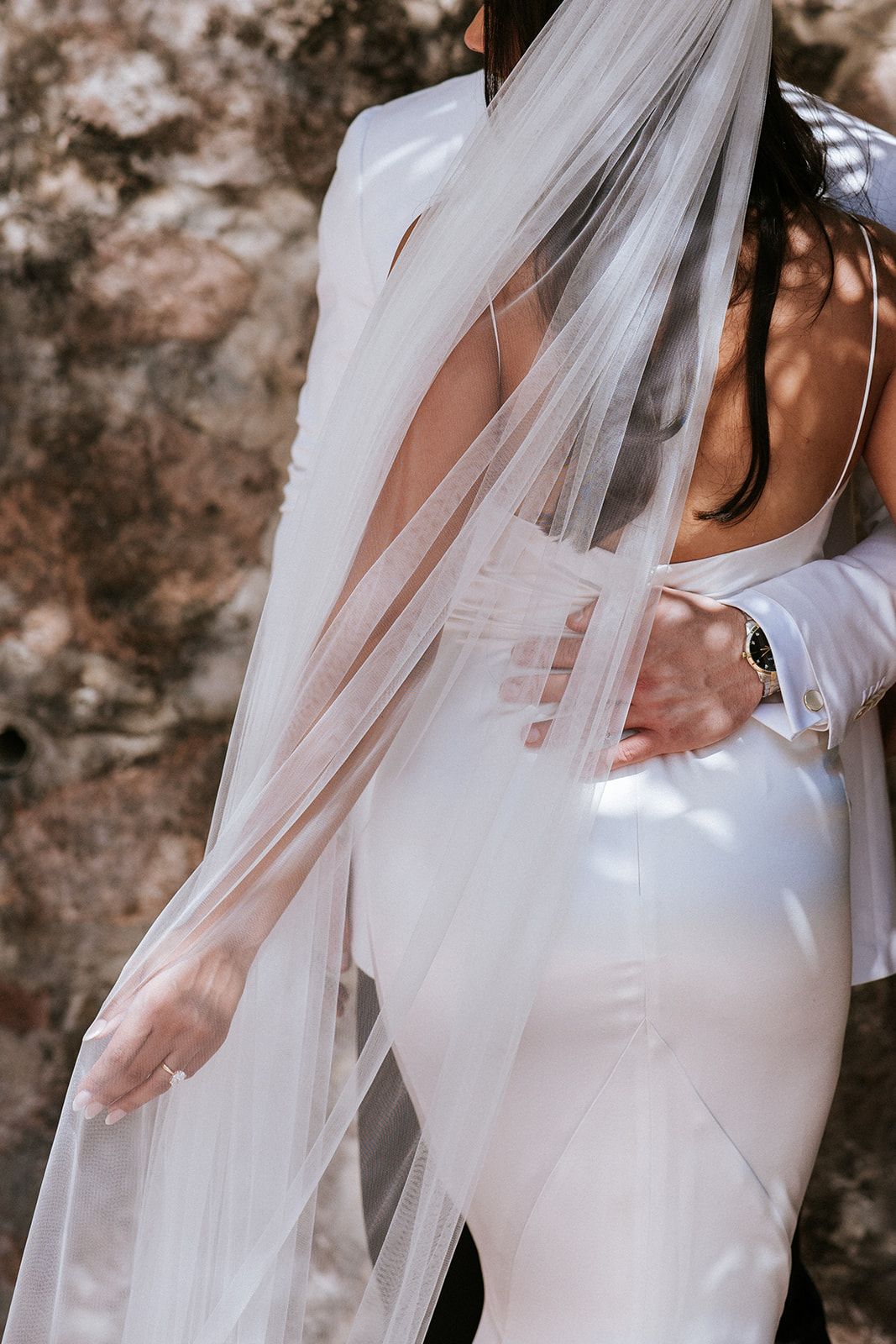 Elegant moment between bride and groom under flowing veil during a luxury destination wedding in Puerto Vallarta by José Carrillo.