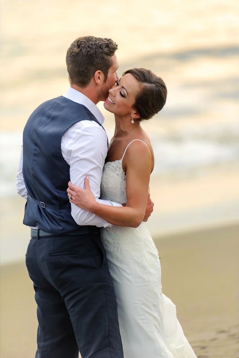 Bride and groom share a tender embrace on the beach at sunset in Puerto Vallarta, captured by destination wedding photographer José Carrillo