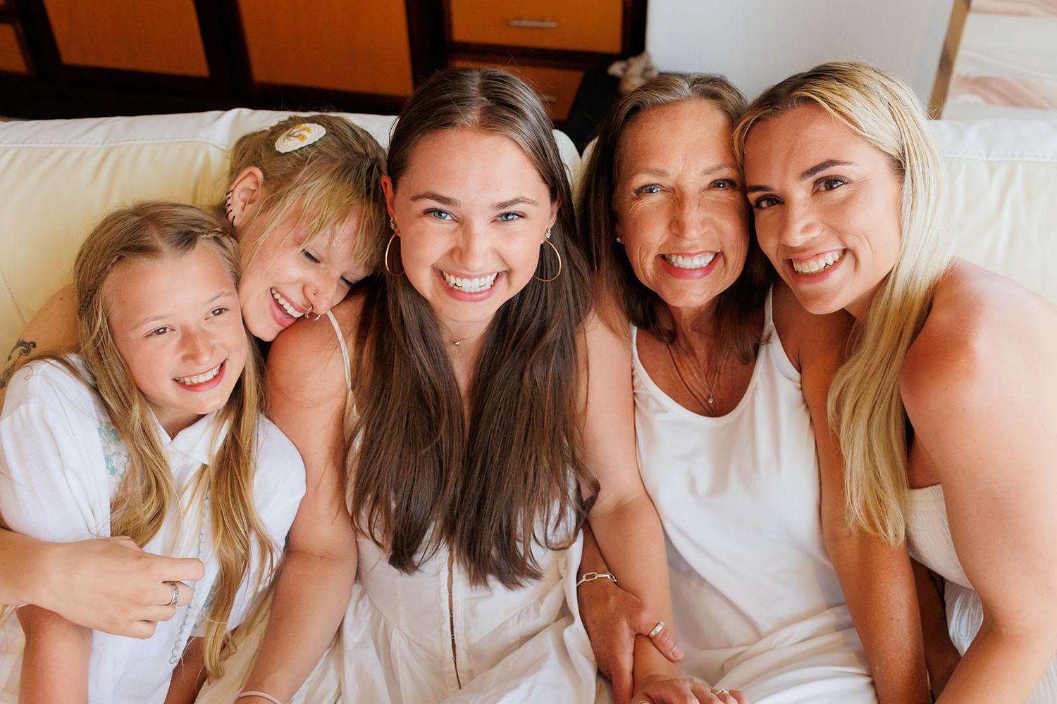 Three generations of women sharing a candid moment during a family photo session in Puerto Vallarta