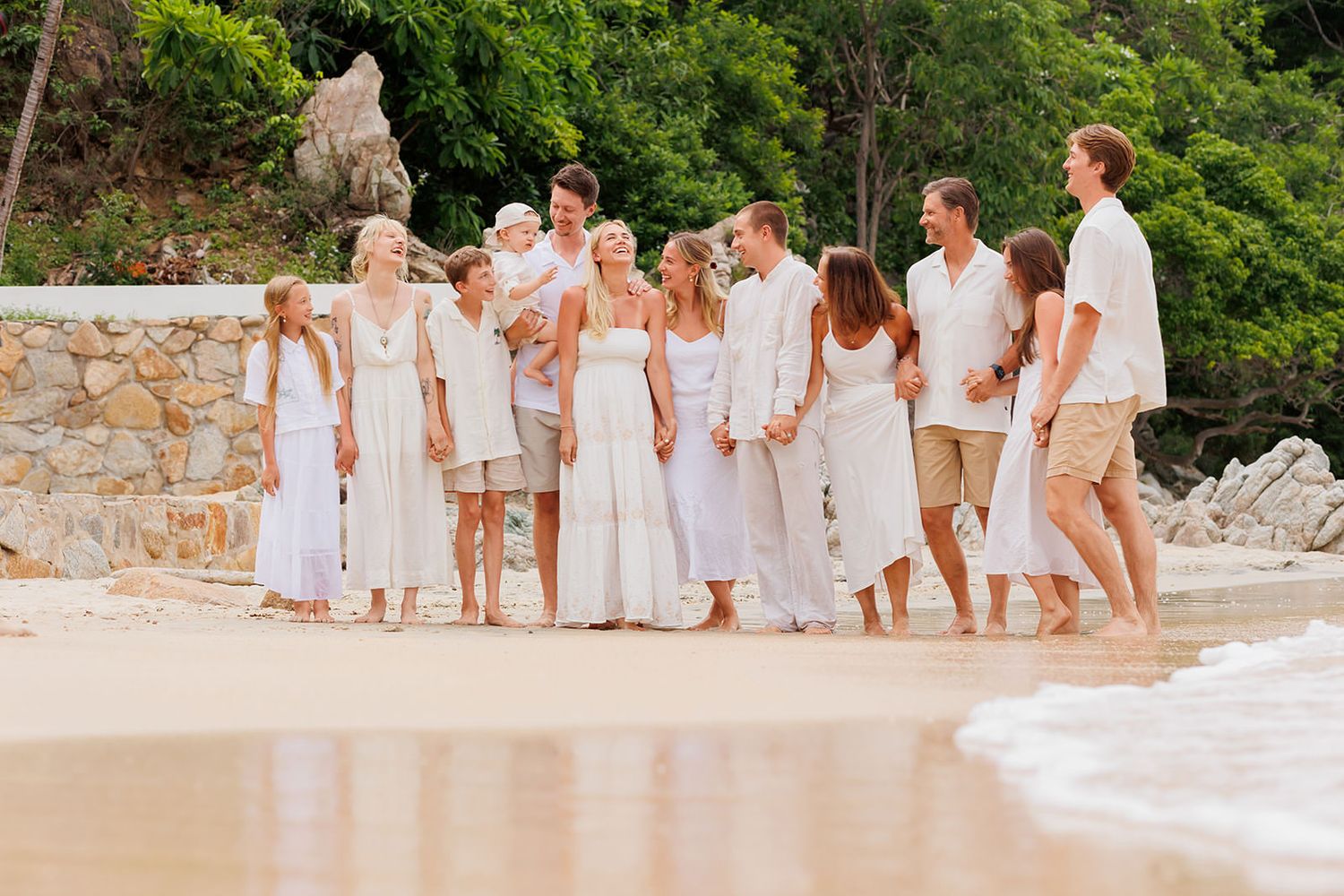 Extended family walking together along the beach during a family photo session in Puerto Vallarta