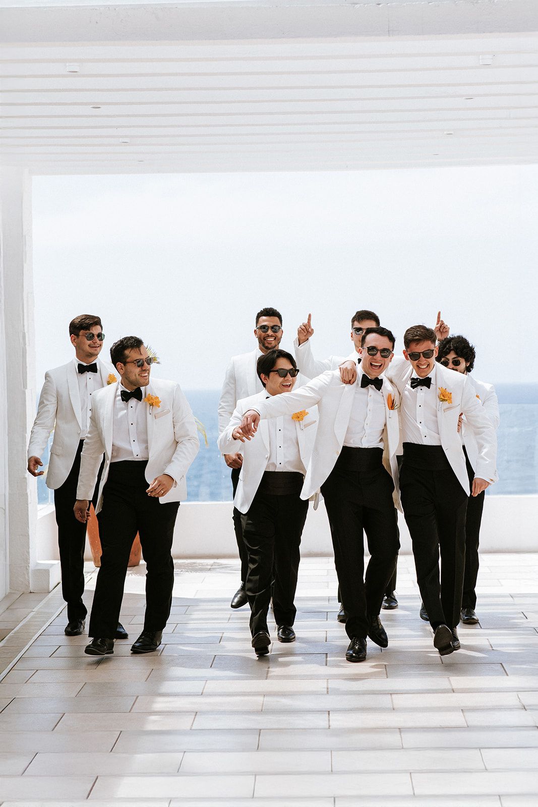 Groom and groomsmen laughing and walking together in Puerto Vallarta before the wedding, by José Carrillo Photography.