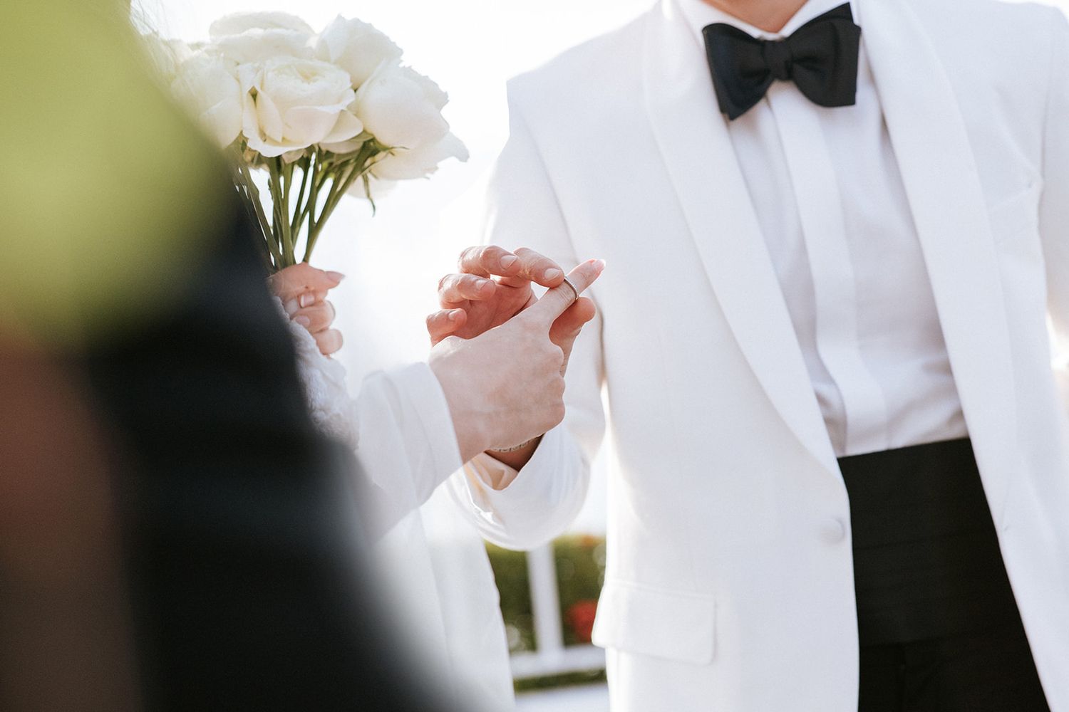 Close-up of groom placing ring on bride’s finger during elegant wedding ceremony in Puerto Vallarta, by José Carrillo Photography.