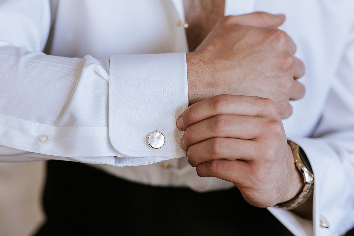 Groom adjusting cufflinks before his luxury destination wedding in Puerto Vallarta, captured by José Carrillo Photography.