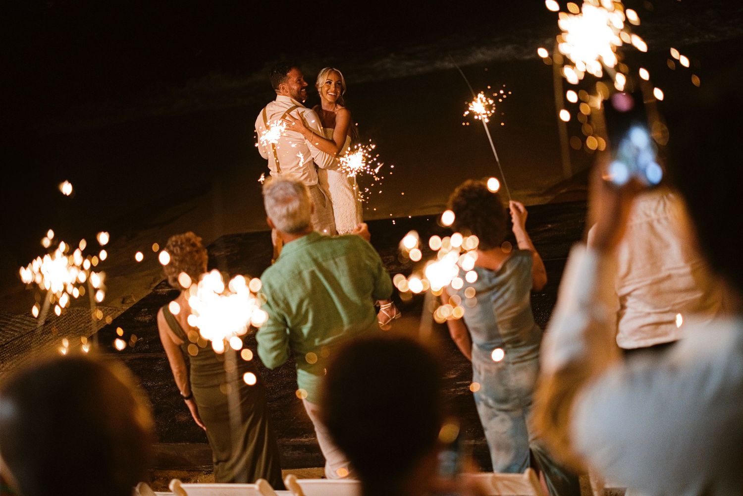 Bride and groom celebrating with sparklers at Las Caletas near Puerto Vallarta