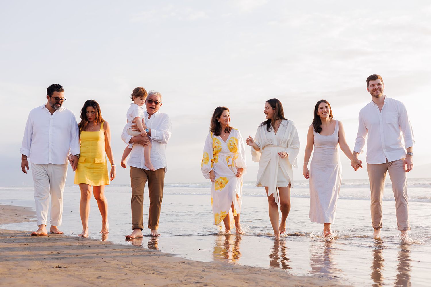 Multigenerational family walking together on the beach at Grand Velas Riviera Nayarit