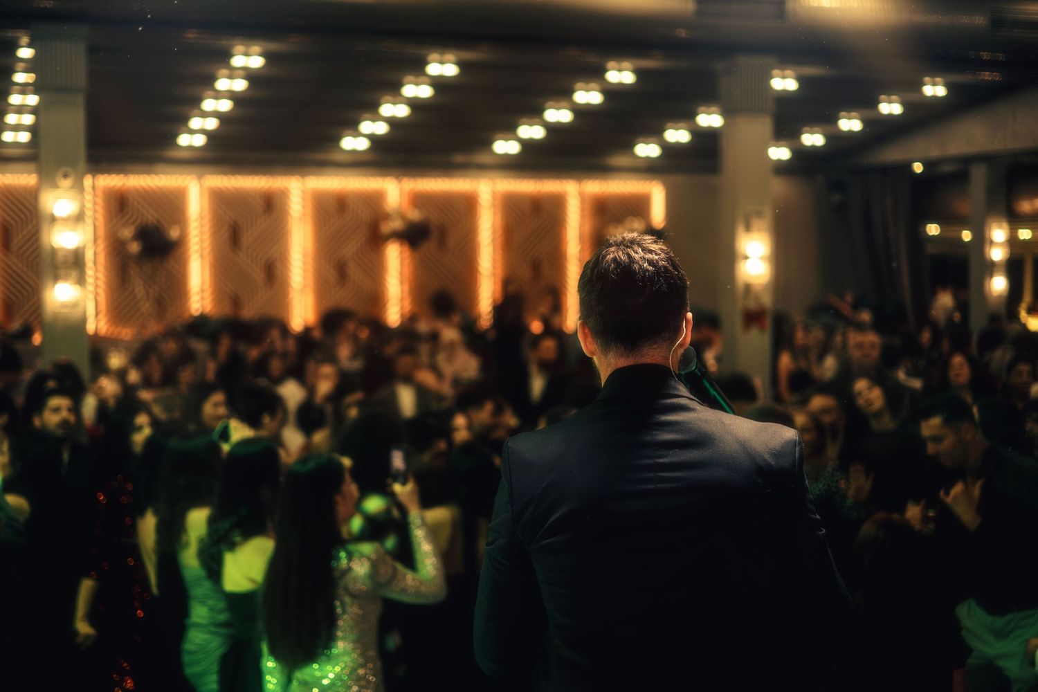 Speaker addressing guests during an indoor wedding reception