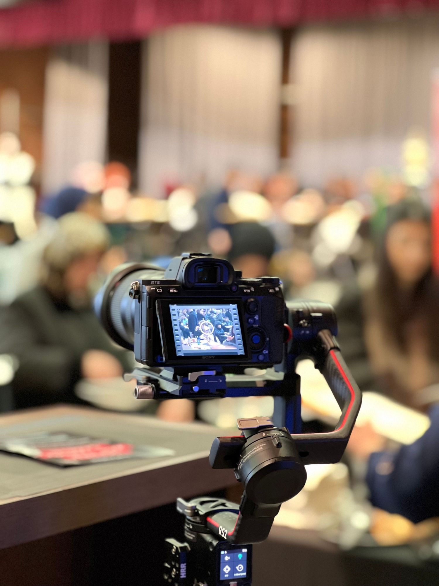 Camera filming a wedding reception during an indoor celebration