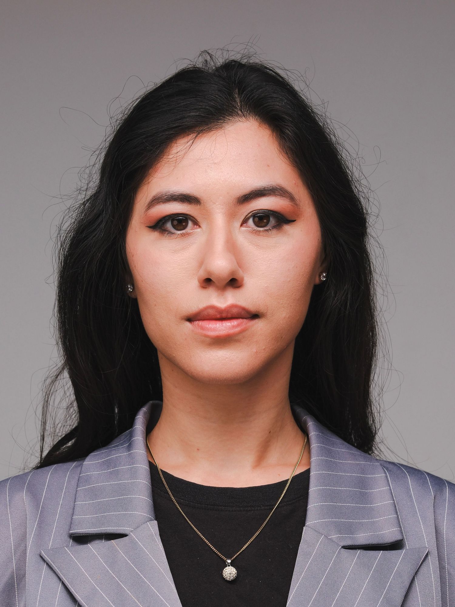 Professional headshot portrait of a woman in a pinstripe blazer photographed in Sydney by Soy Latte Lee