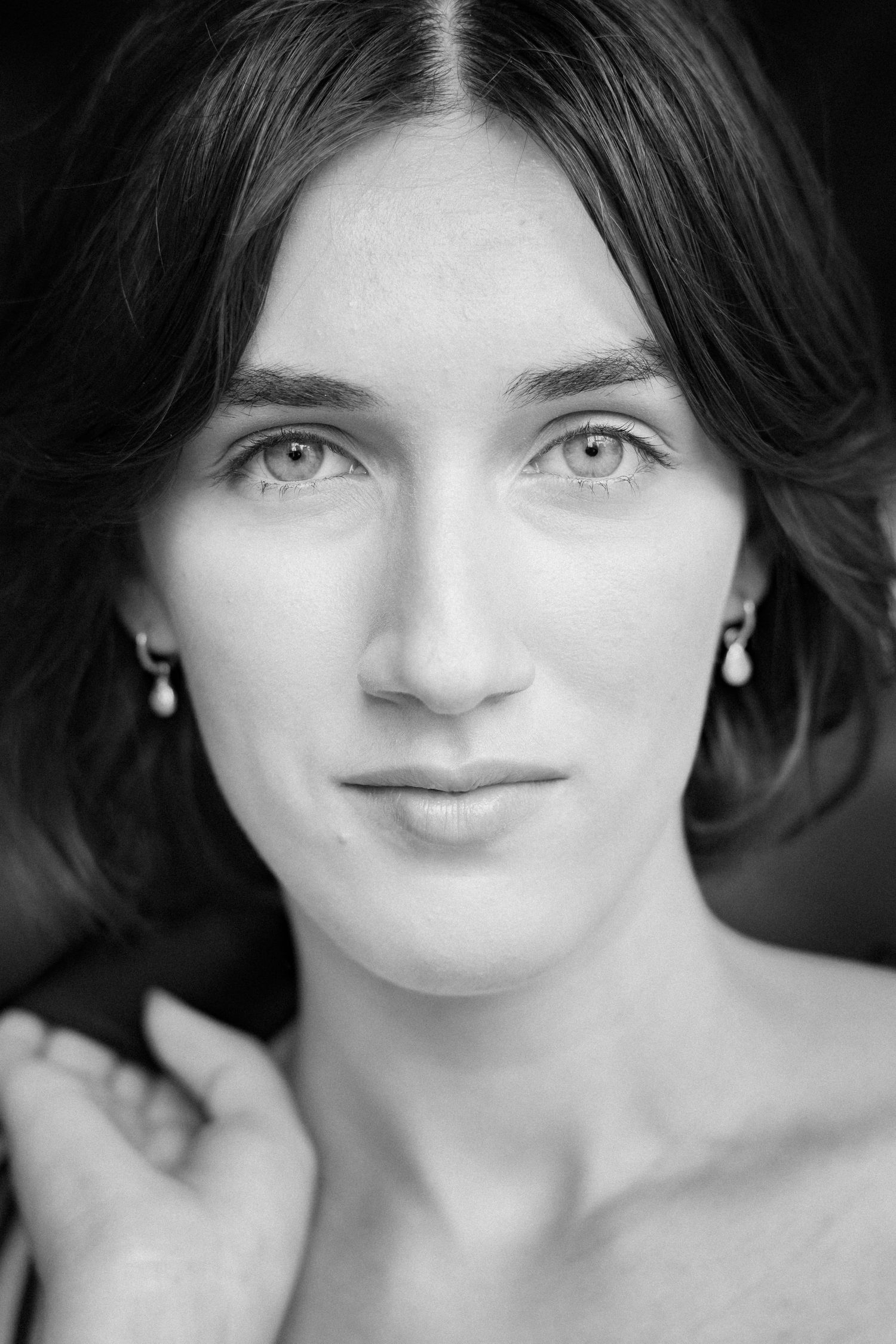 Black and white close-up portrait of a woman with direct eye contact in a Burwood park.