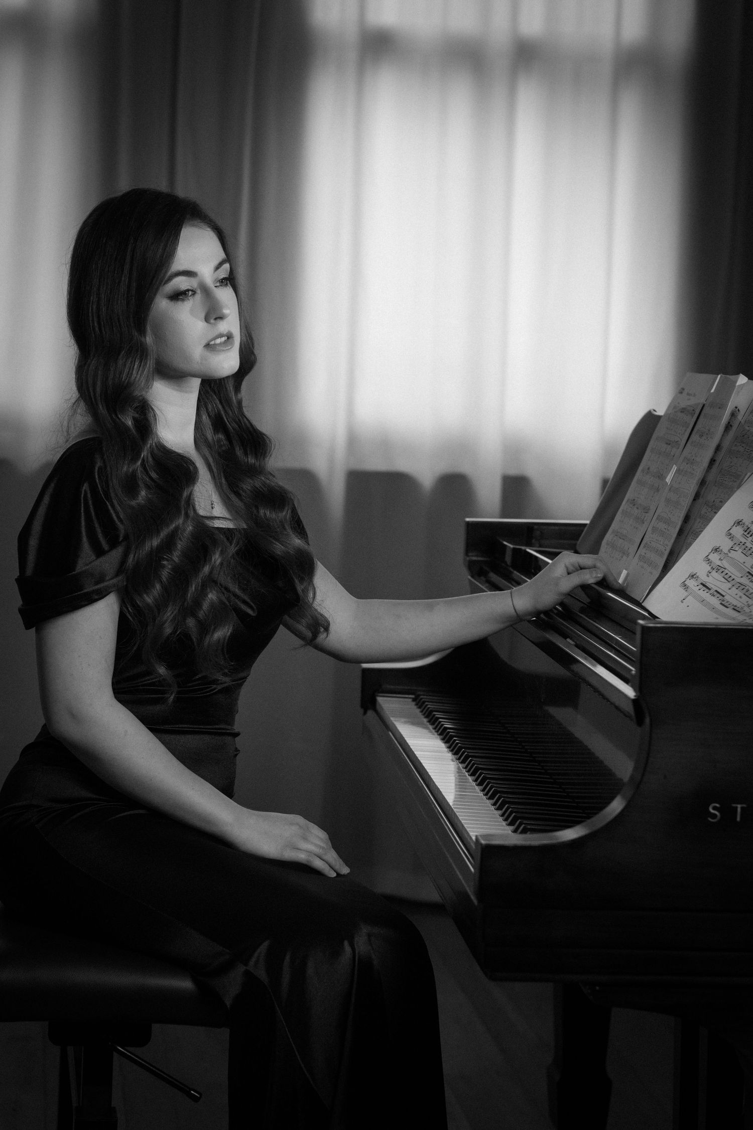 Environmental portrait of a woman at a piano studio in Glebe, Sydney using soft natural window light.