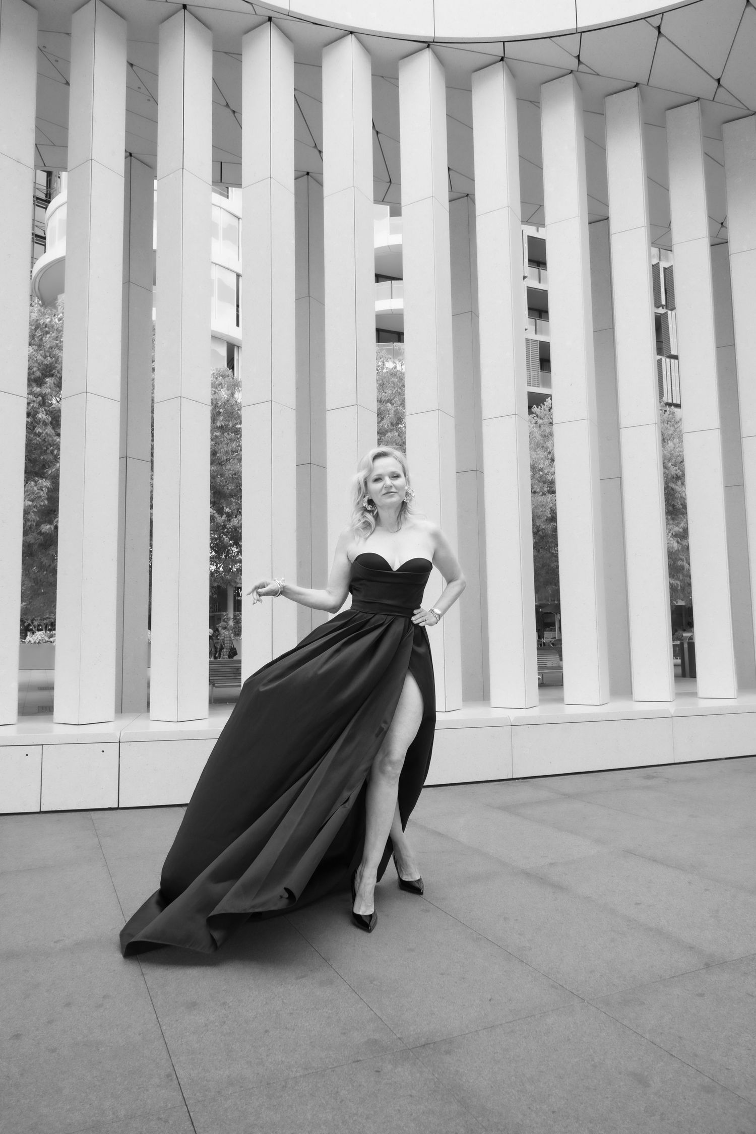 Woman in a black dress photographed among architectural columns in Sydney