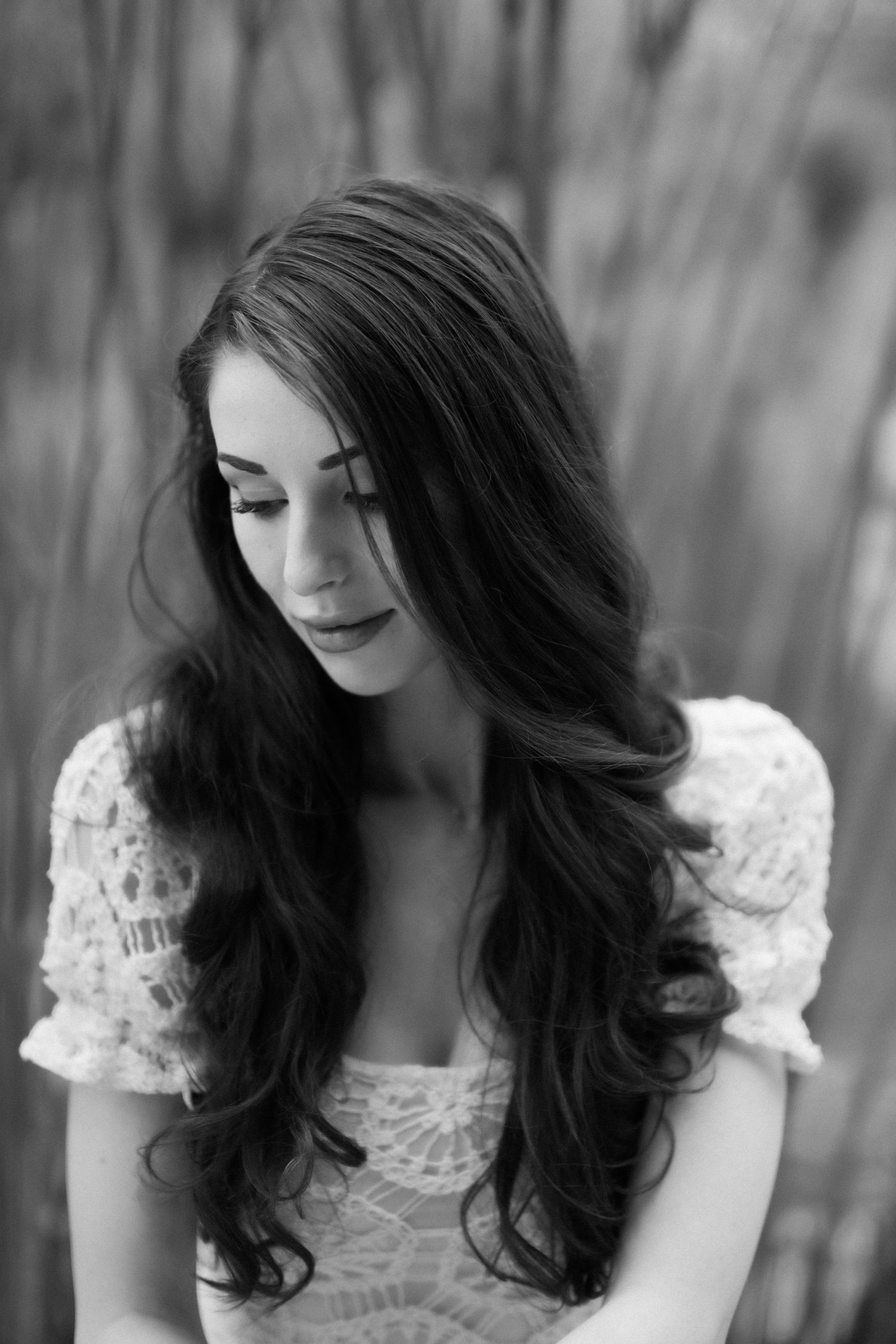 Black and white portrait of a woman looking into the distance in a peaceful Burwood park.