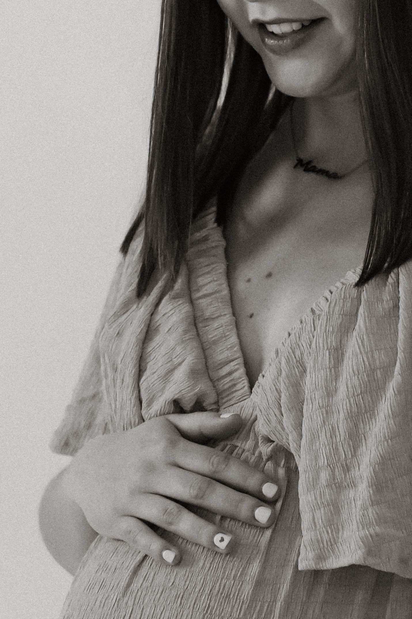 A series of black and white photos showing someone wearing a light-colored top and gesturing with their hands.