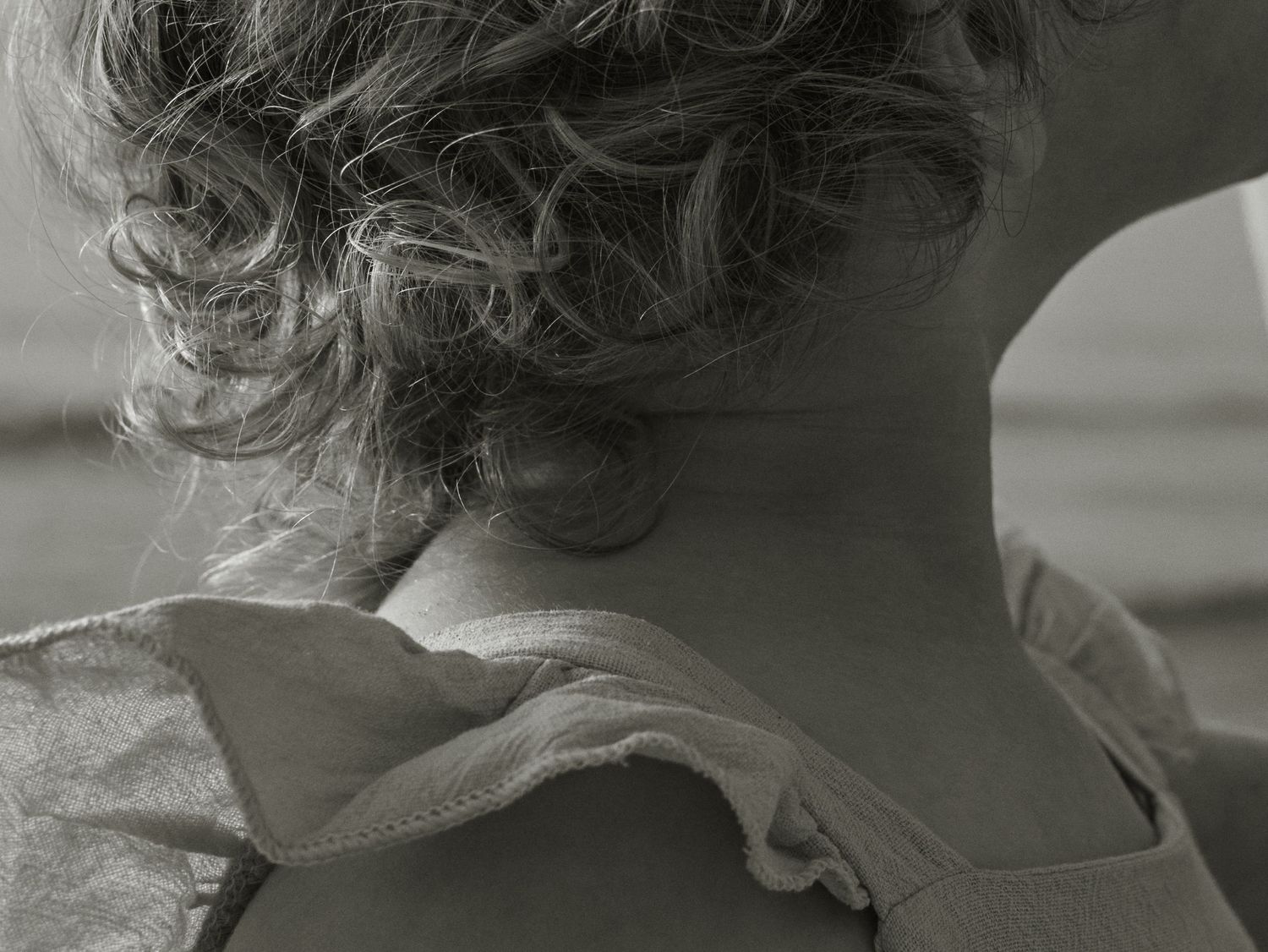 Close-up black and white portrait series focusing on hair texture and natural light.