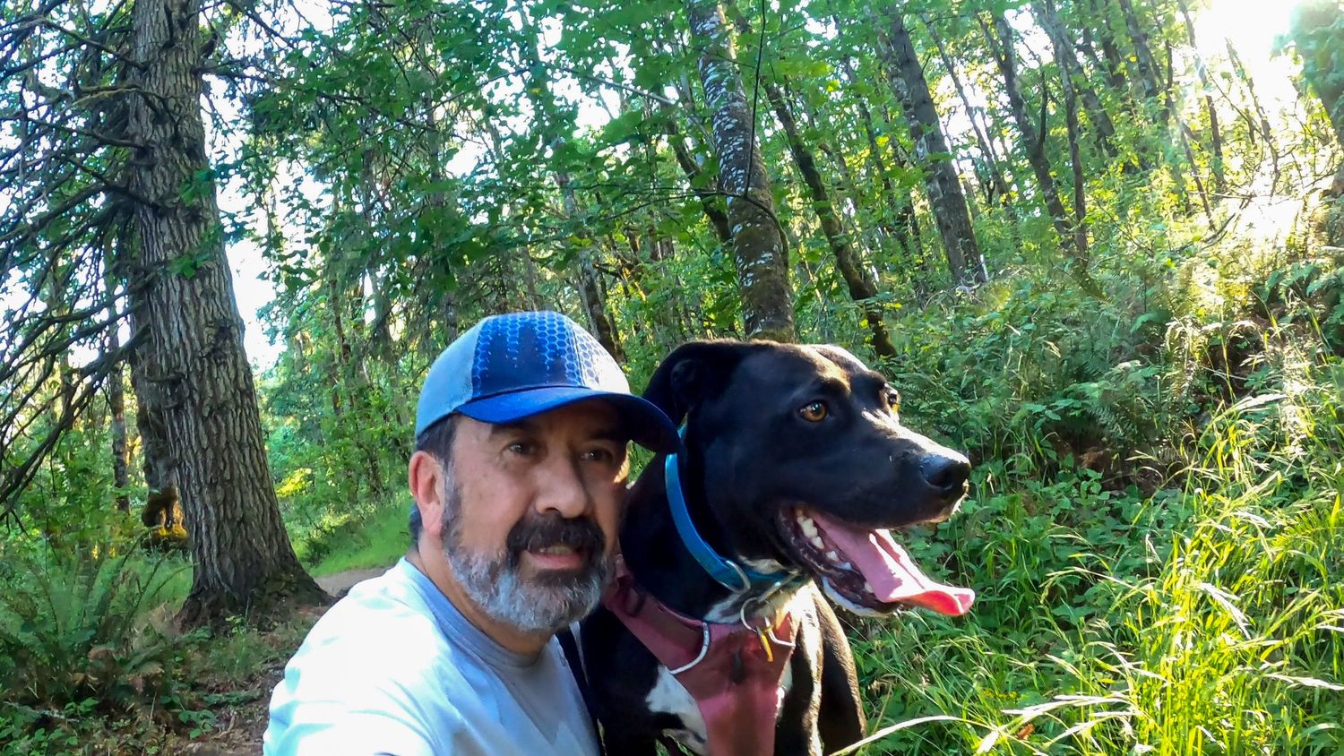 Trail runner and his trail dog taking a break on a trail in Eugene Oregon.