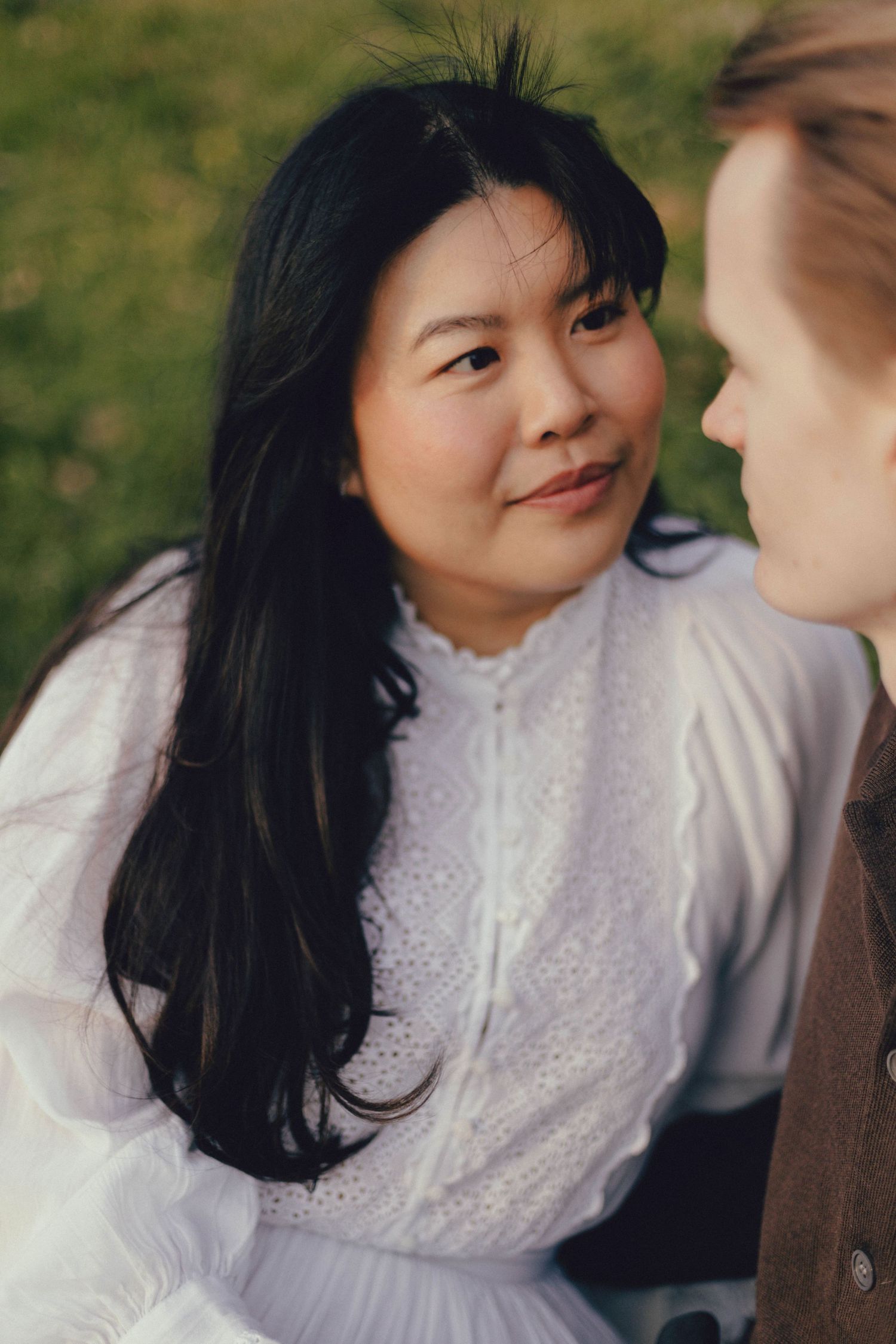 A series of intimate portraits showing tender moments between two people in a garden setting, with soft natural lighting.
