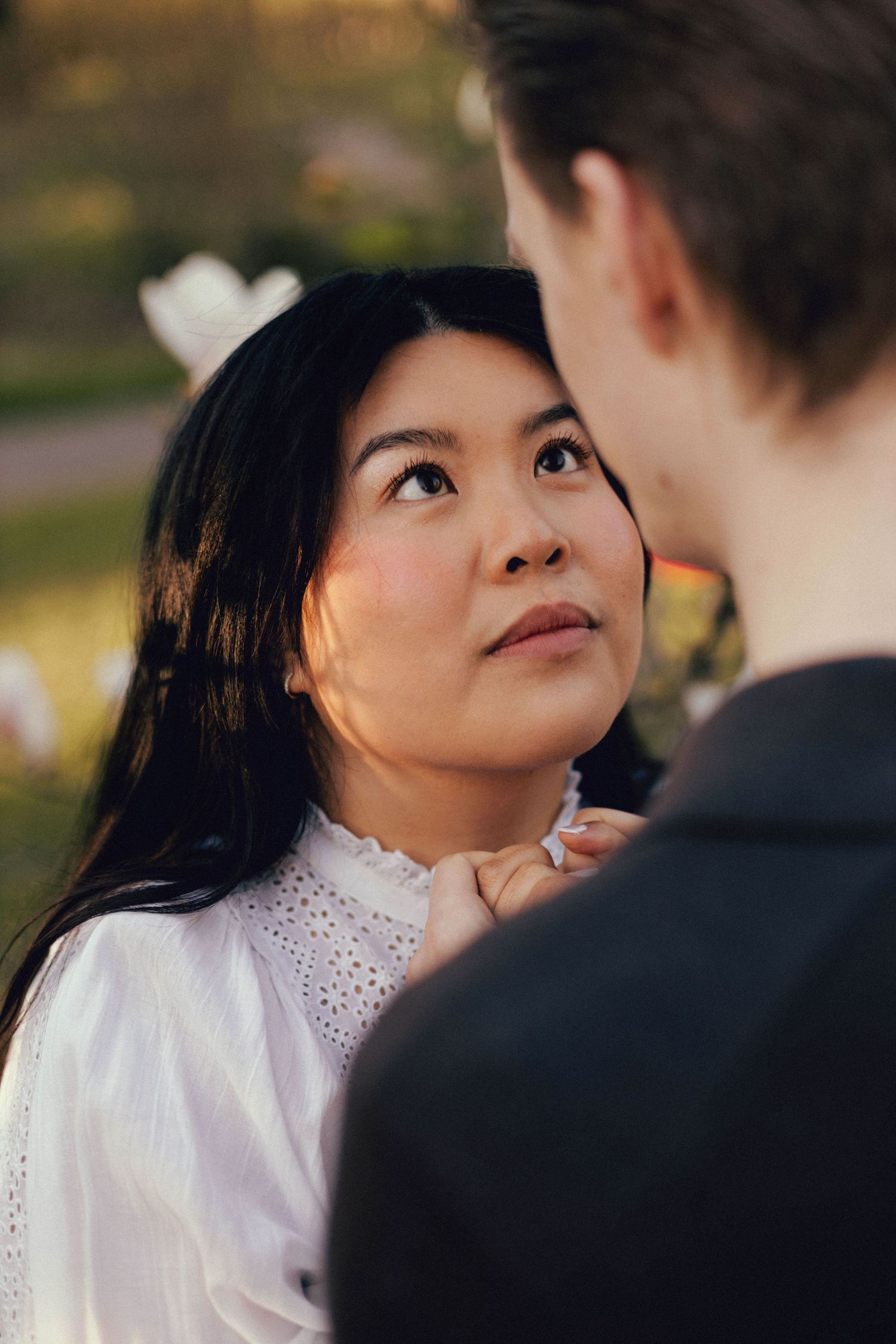 Close up photos of a couple in white clothing sharing intimate moments during a romantic outdoor photoshoot.