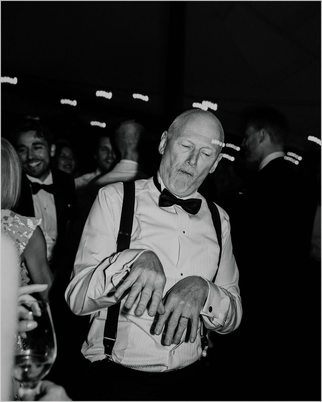 A sequence of black and white photos showing hands performing a card trick or sleight of hand magic trick.