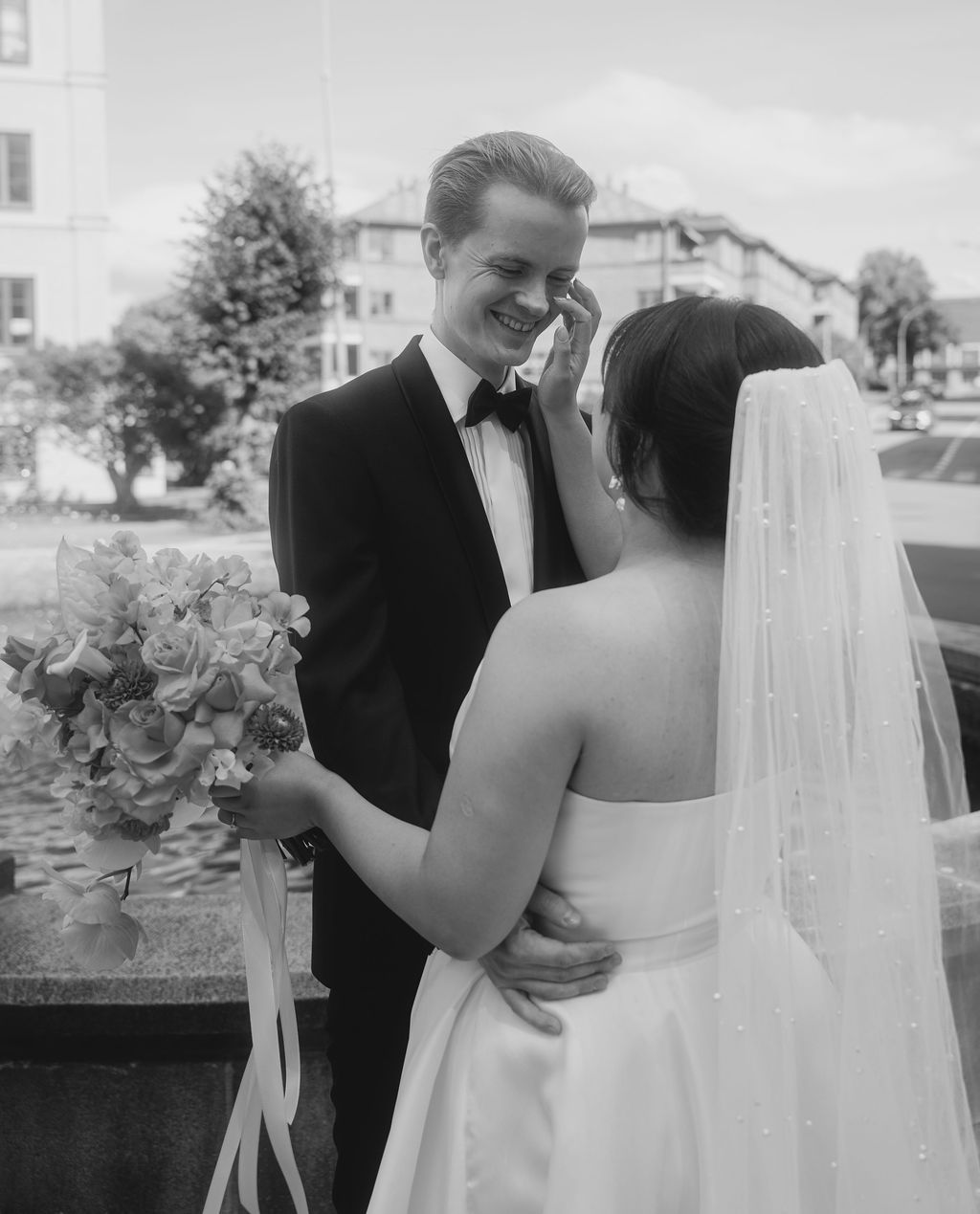 Black and white wedding photos show tender moments between newlyweds during their outdoor ceremony.