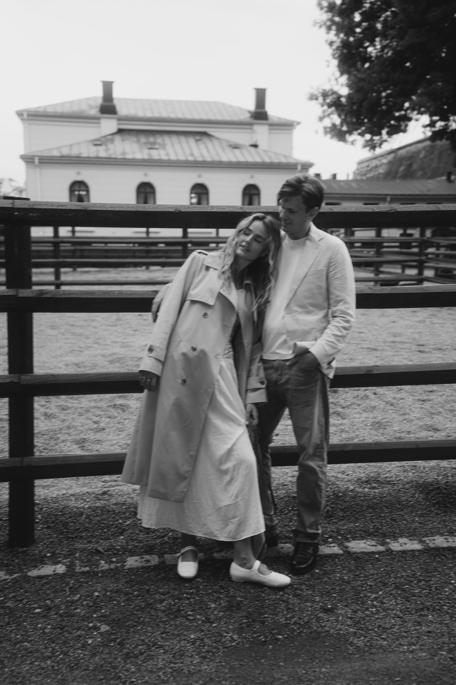 A series of black and white photos showing a couple sharing a tender moment outdoors near a fence.