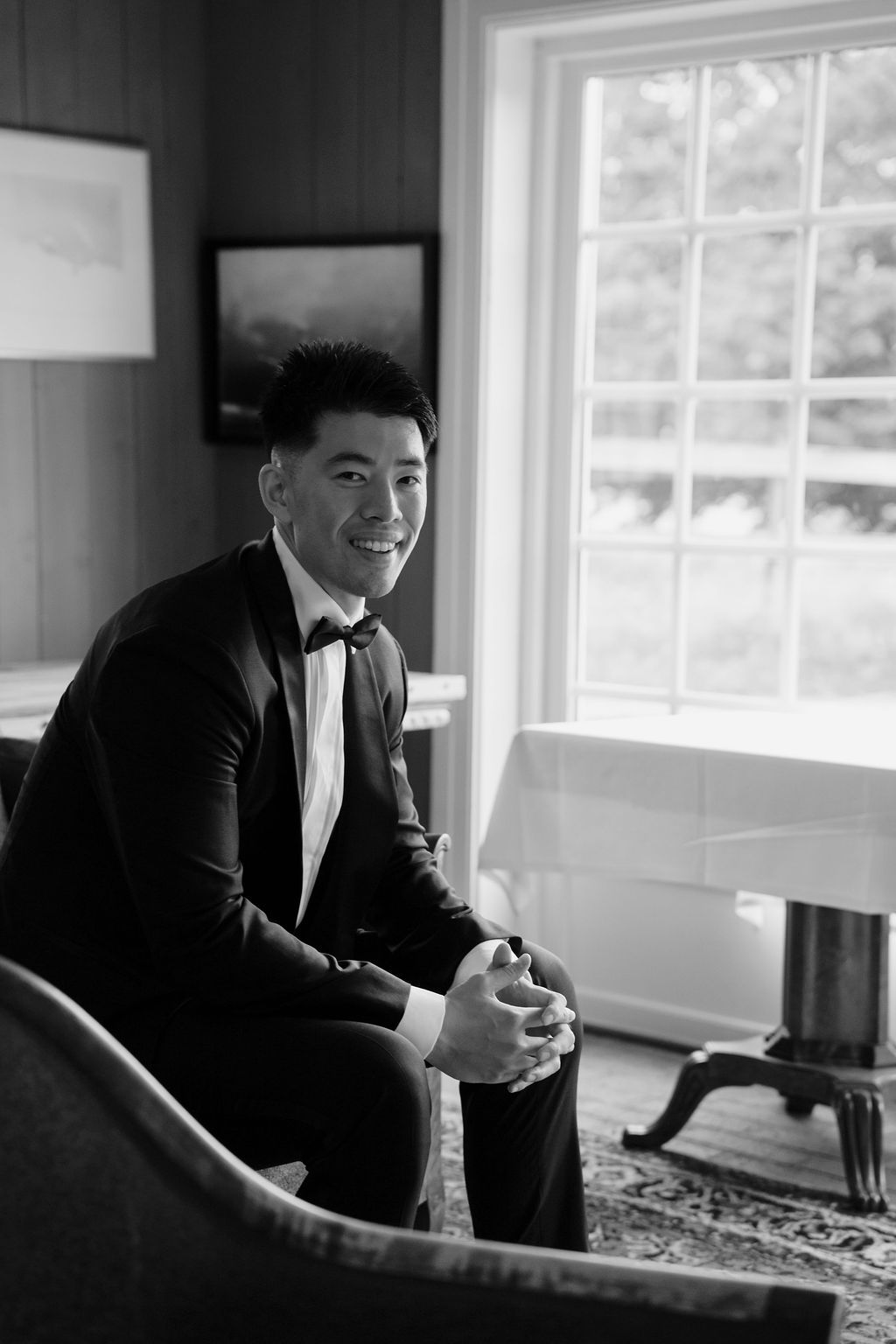 Black and white photos show someone in formal attire seated by bright windows.