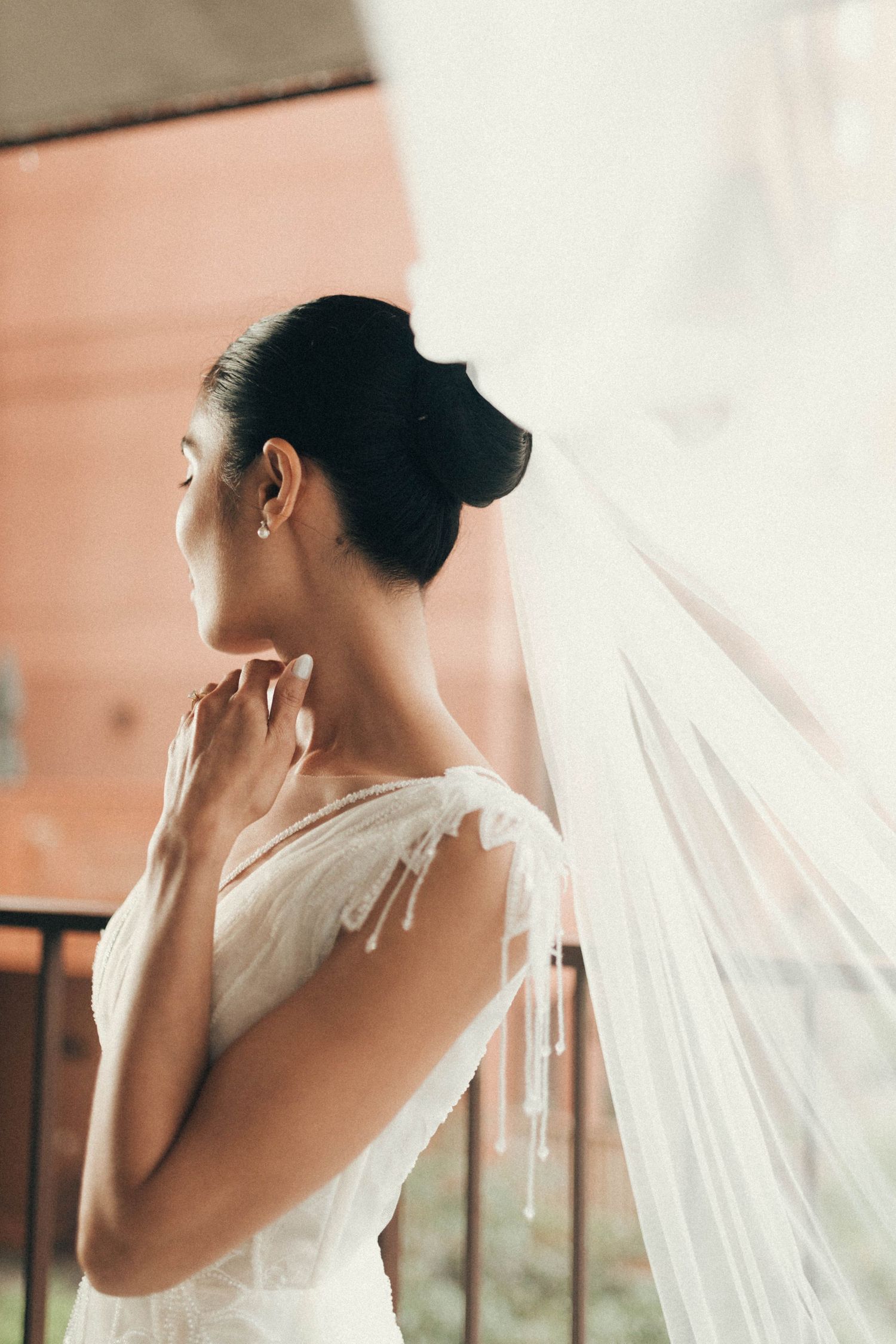 A series of elegant bridal portraits showing the back and profile views of a bride in a white dress with flowing veil.