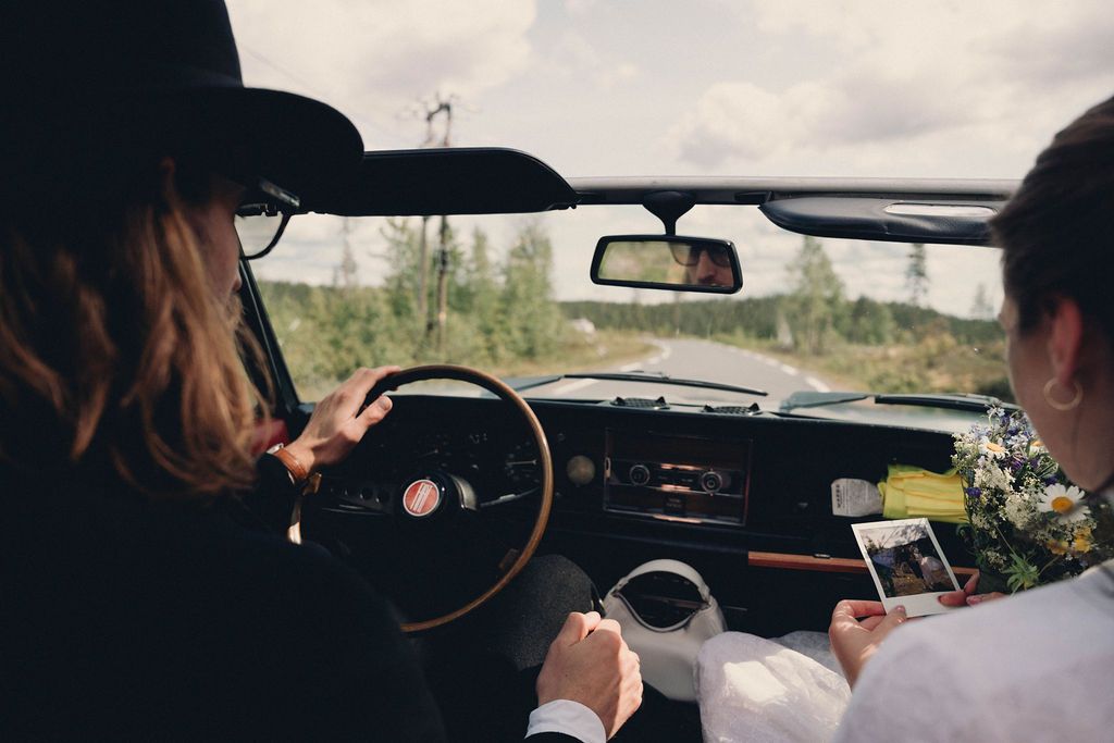 A collection of car interior dashboard views showing navigation screens and steering wheels during a road trip.