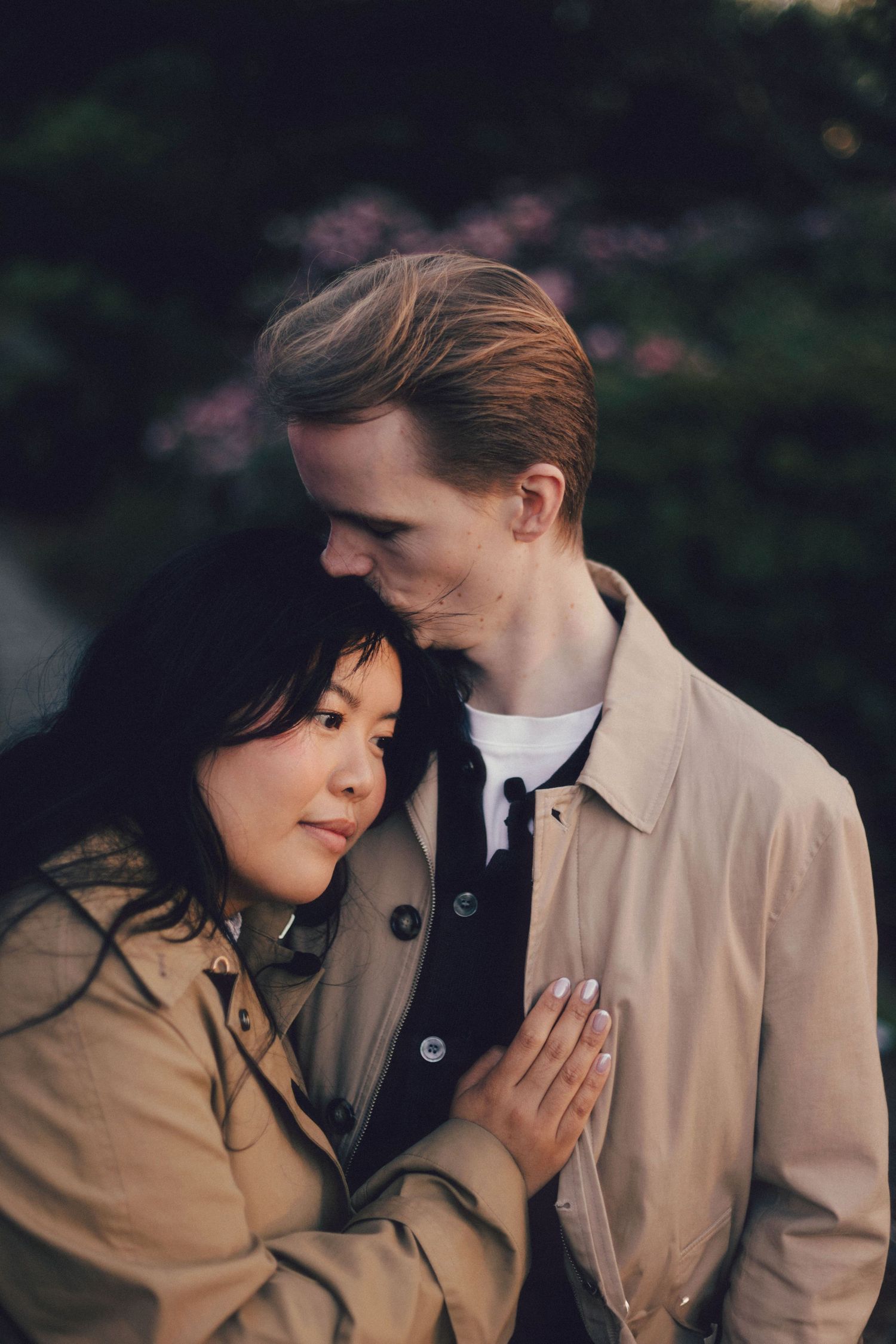 A romantic couple in matching beige coats share intimate moments in a series of candid outdoor photographs.