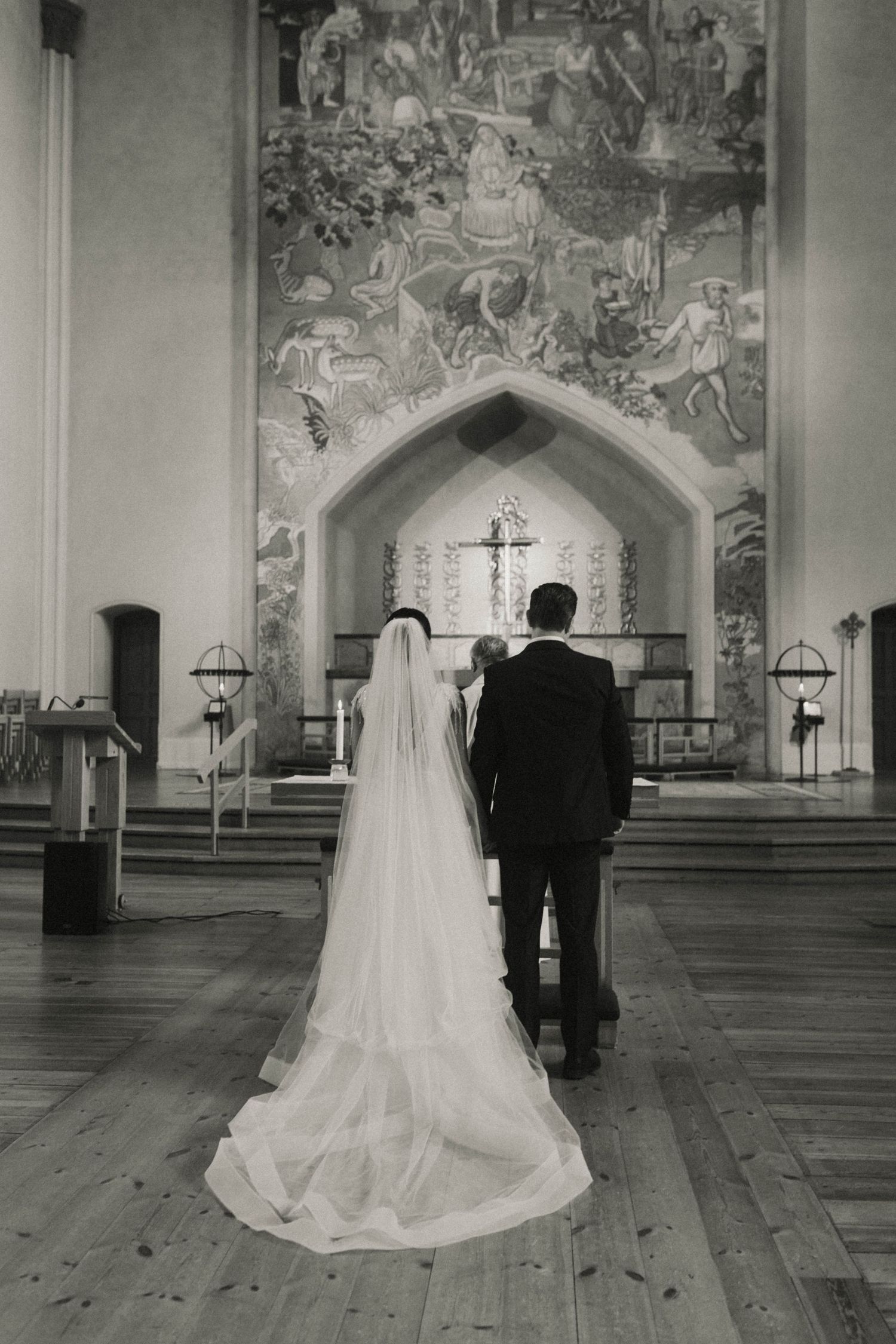 A bride and groom stand in a church with ornate frescoed walls and wooden floors, shown in multiple sequential views.