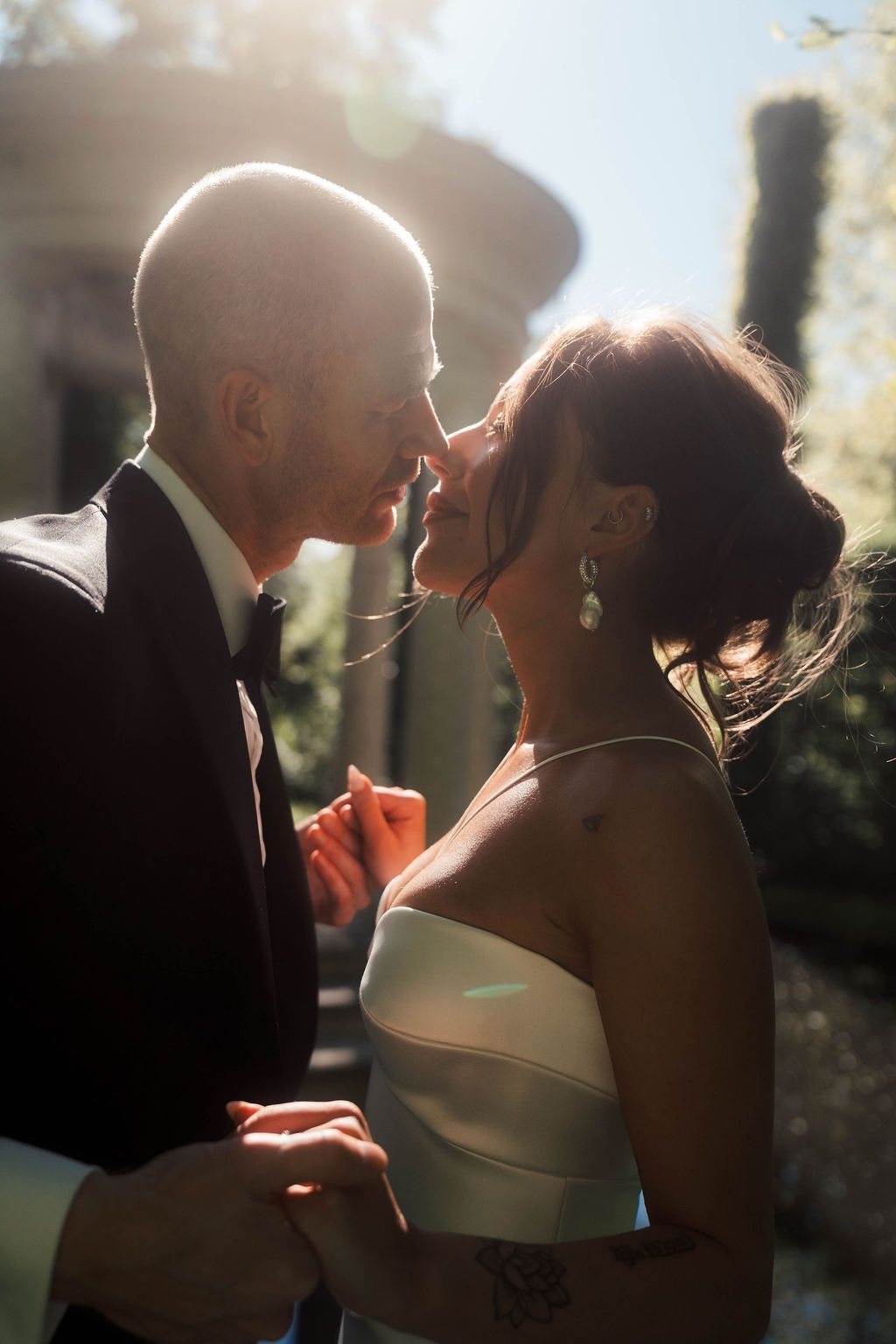 A romantic wedding couple shares intimate moments in a series of backlit silhouette photos during sunset.