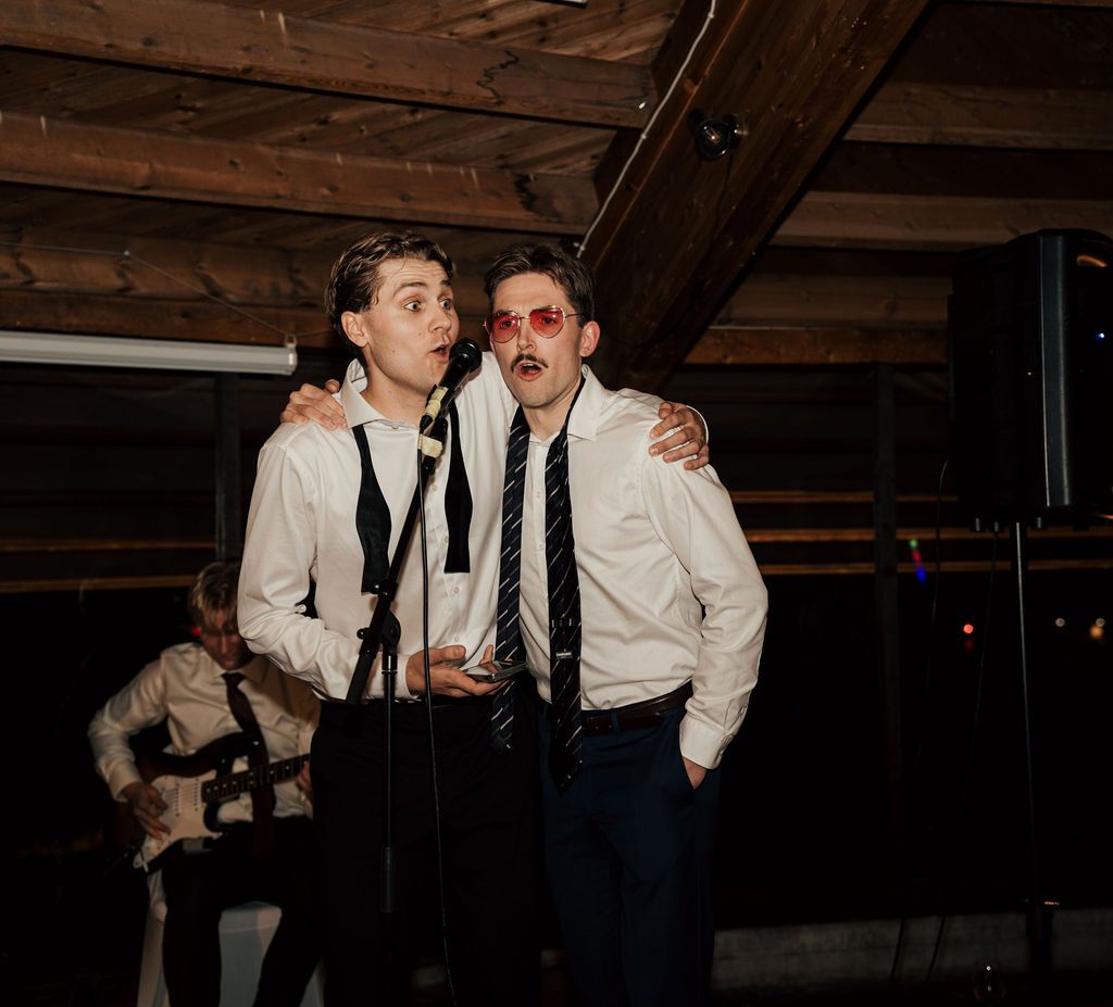 A black and white photo series of people dancing and celebrating at a dimly lit indoor reception venue.
