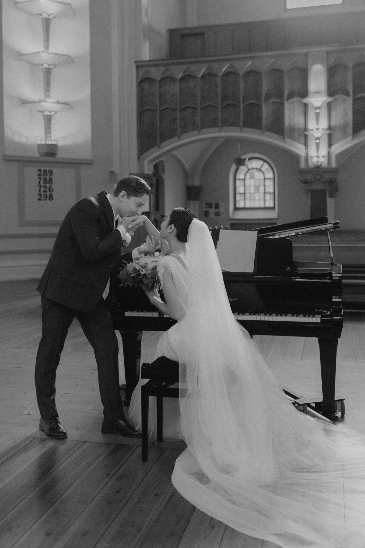 A romantic black and white photo sequence shows a couple in wedding attire dancing and dipping near a piano.