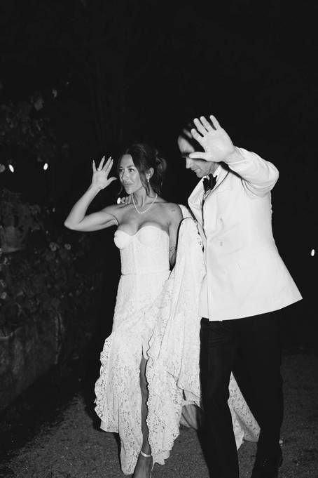People in white dresses dance together at night in a haunting and ethereal scene.