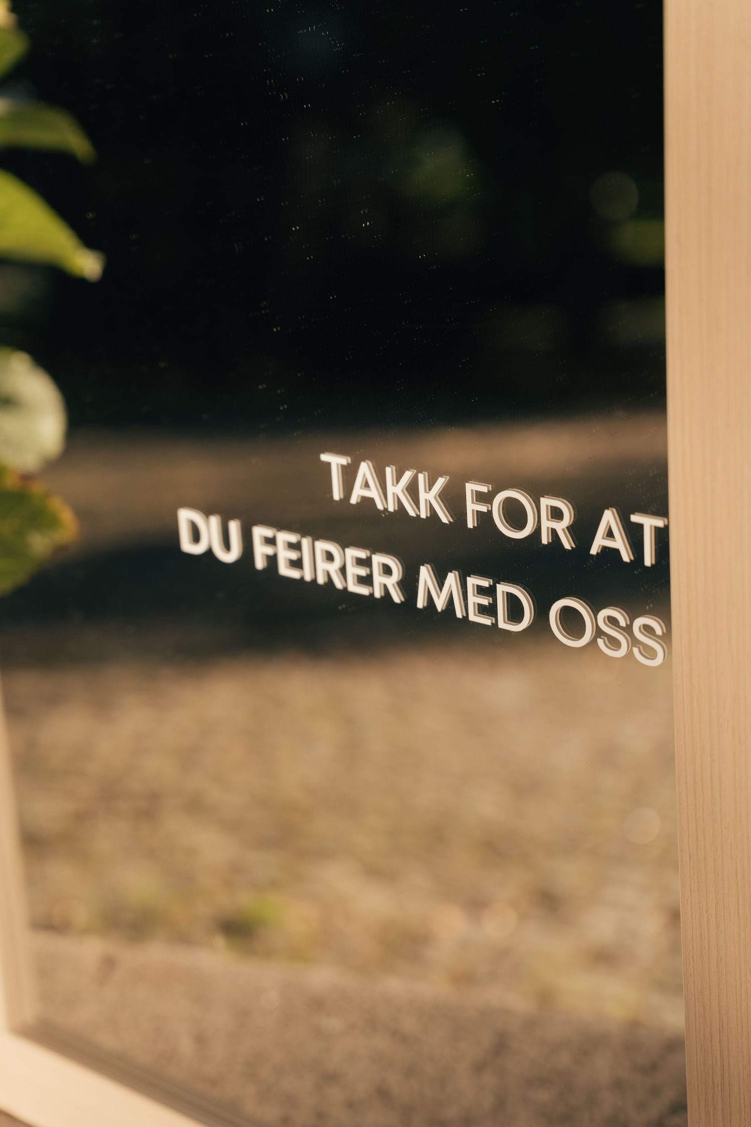 Norwegian wedding sign reading TAKK FOR AT DU FEIRER MED OSS meaning thank you for celebrating with us.