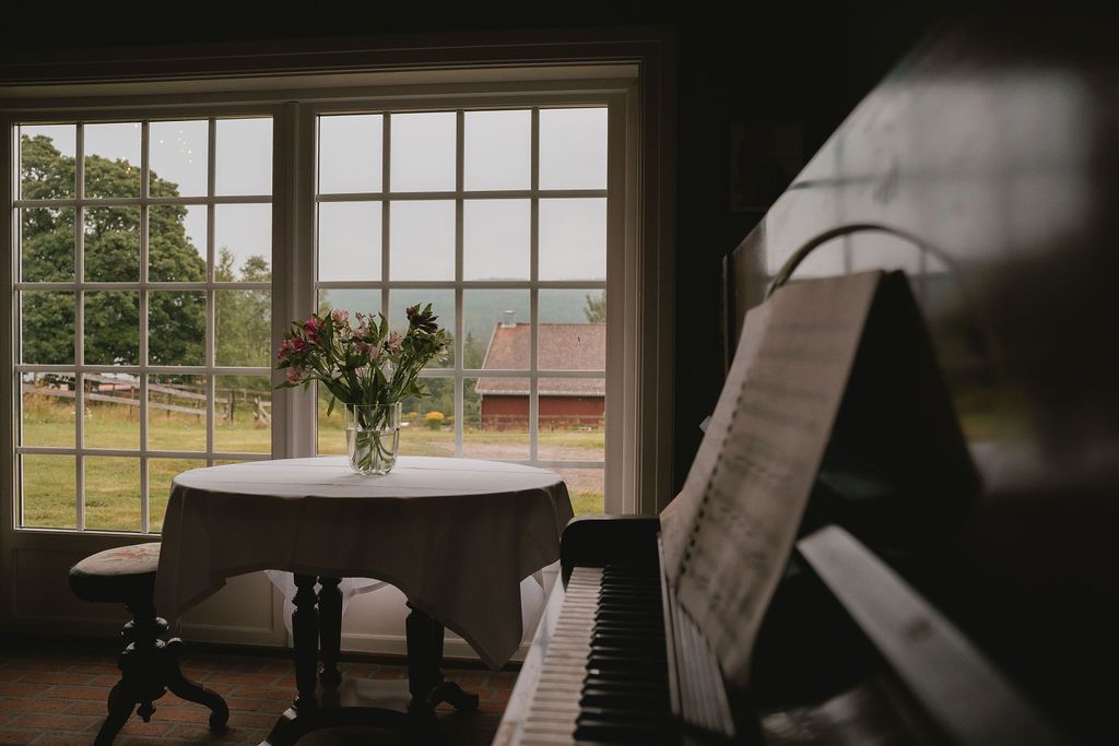Minimalist interior space with large windows letting in natural light and simple table settings.