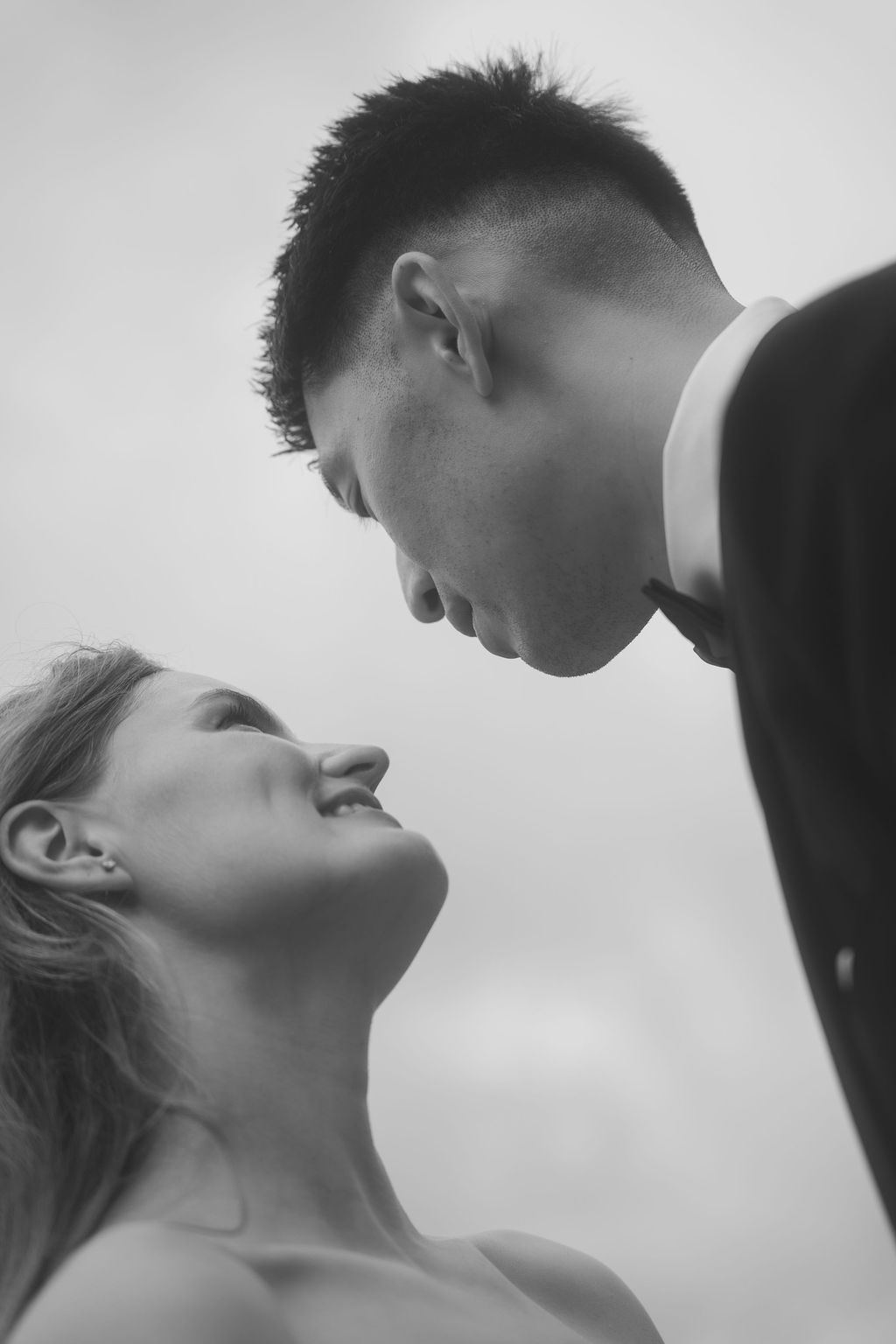 A romantic black and white photo series showing intimate moments between a couple in profile view.