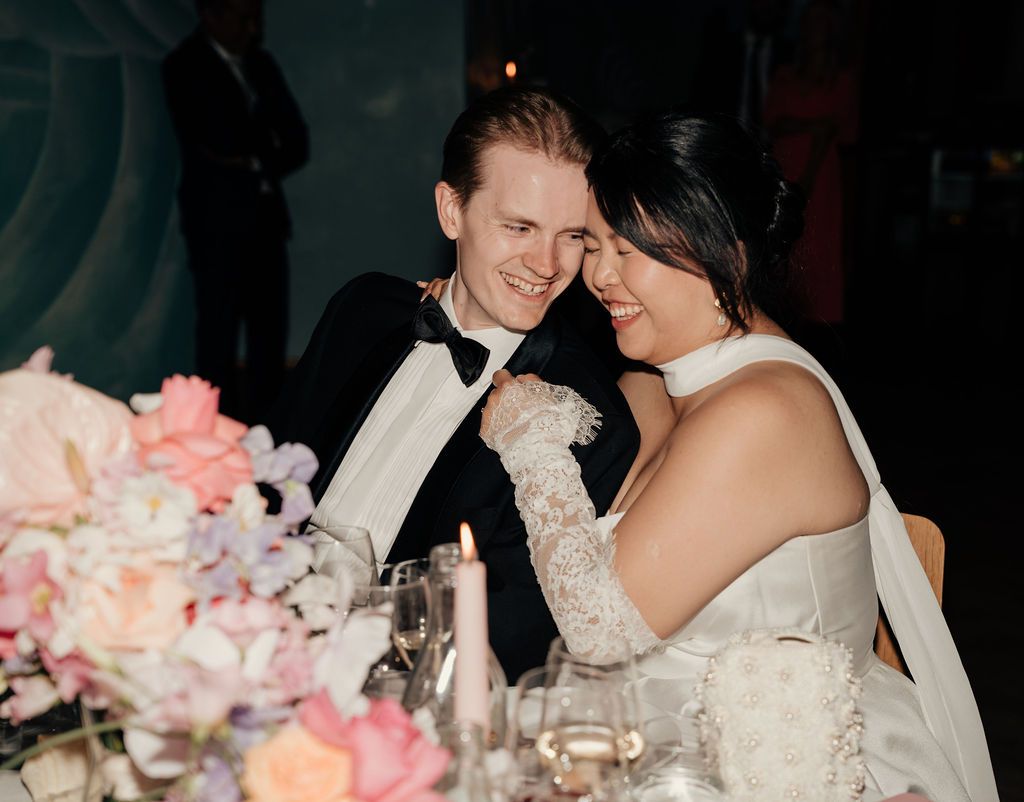 Couples dancing and celebrating at an elegant wedding reception with soft lighting and floral centerpieces.