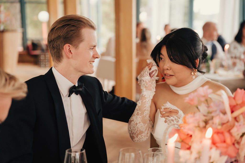 A series of candid wedding reception photos showing guests dining and socializing at elegant tables with pink floral centerpieces.