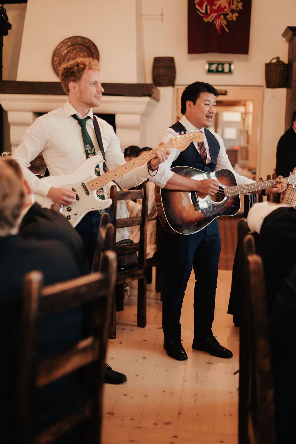 A sequence of four photos showing a musician performing with an acoustic guitar in a rustic indoor venue.