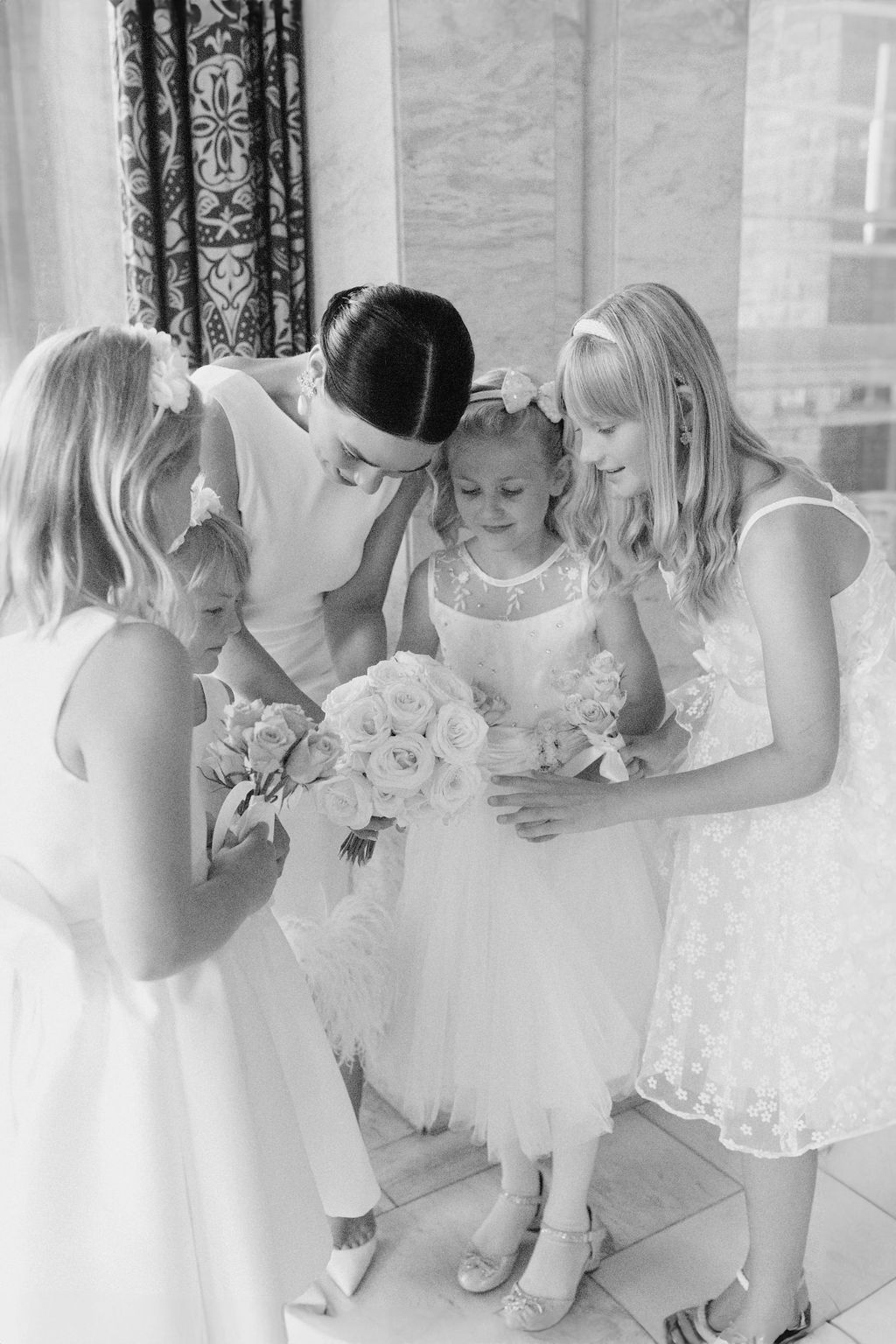 A series of black and white photos showing flower girls in white dresses gathered together at a wedding.