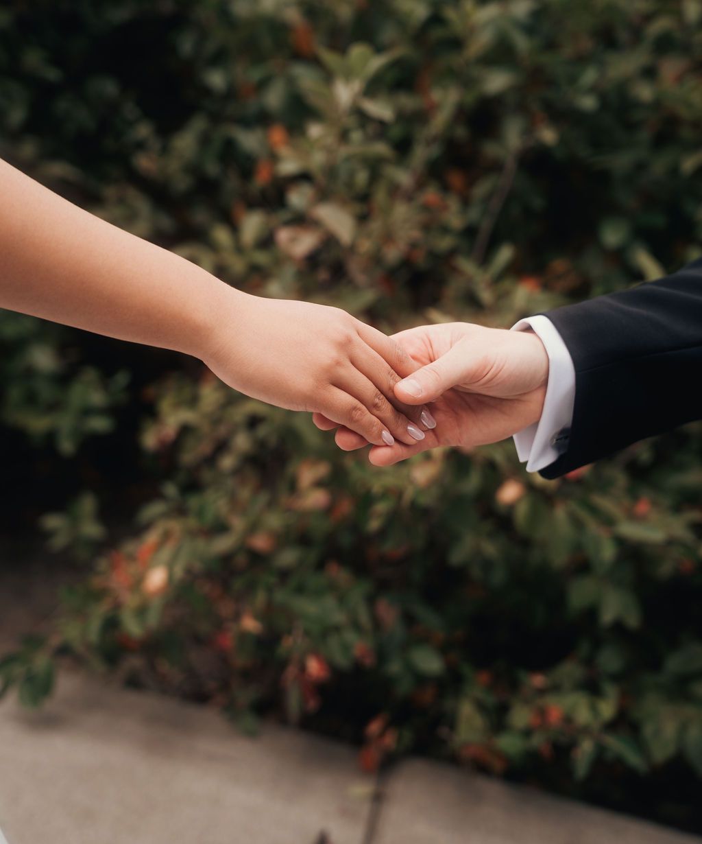 A sequence of hands reaching out and connecting in a horizontal progression against a dark background.