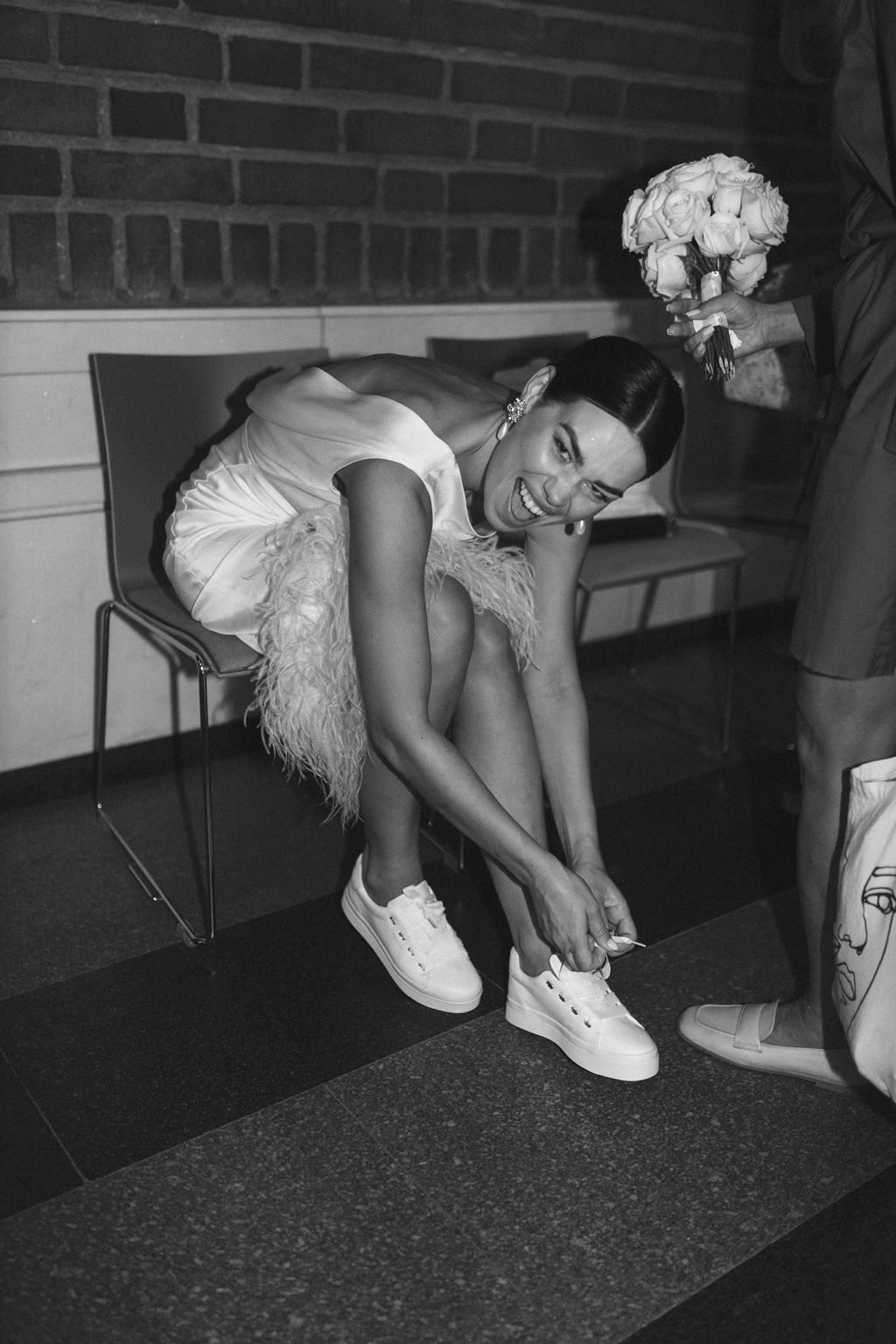 A sequence of black and white photos showing someone in white clothing crouching down near a brick wall.