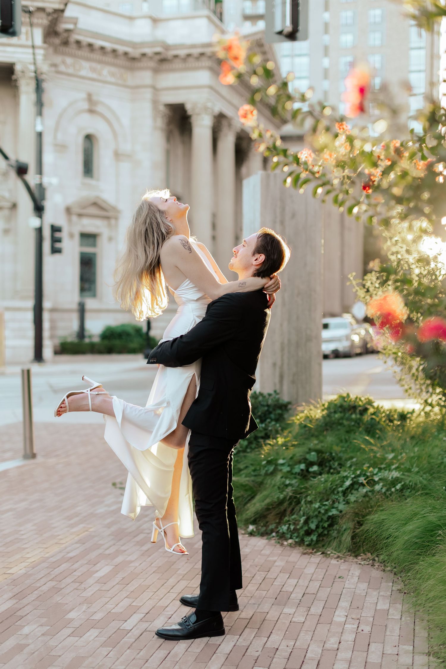 Romantic wedding dance sequence showing a dip pose against an elegant architectural backdrop.
