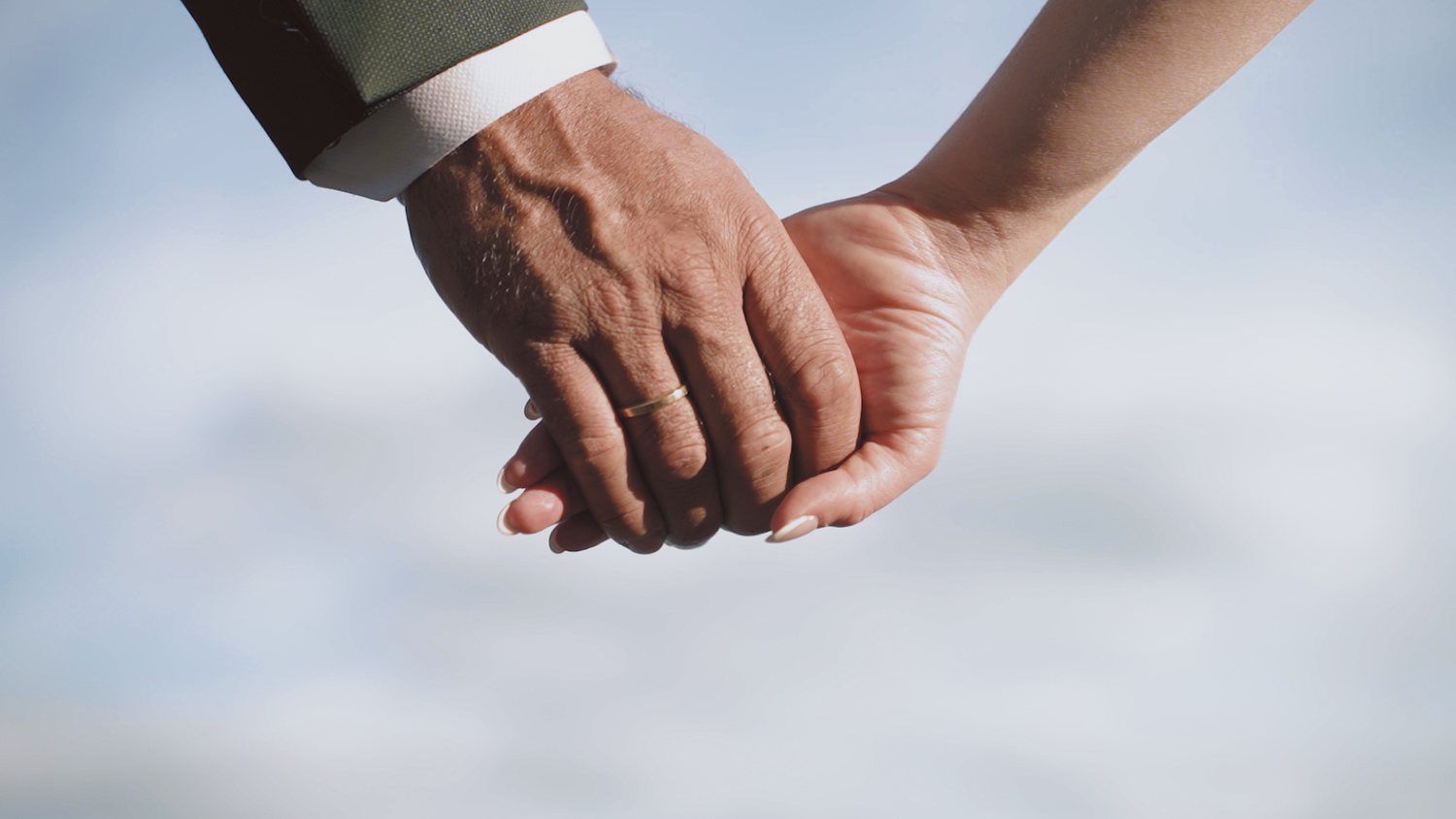 Groom and bride holding hands, cinematic shot,
