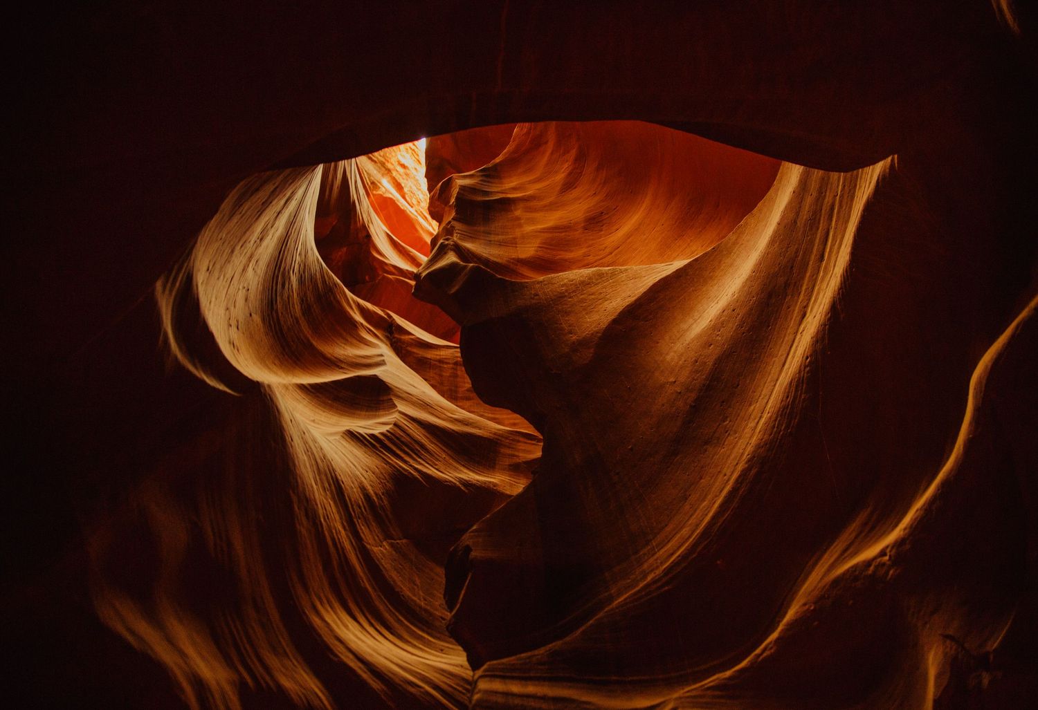 Stunning Antelope Canyon slot canyon with glowing orange and red sandstone walls sculpted by water erosion in Arizona.