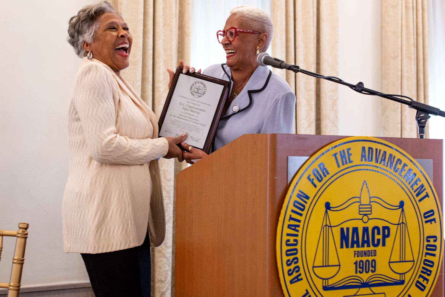 Congresswoman Joyce Beatty(left) accepts an award from the presidents if the Ohio chapter of the NAACP.