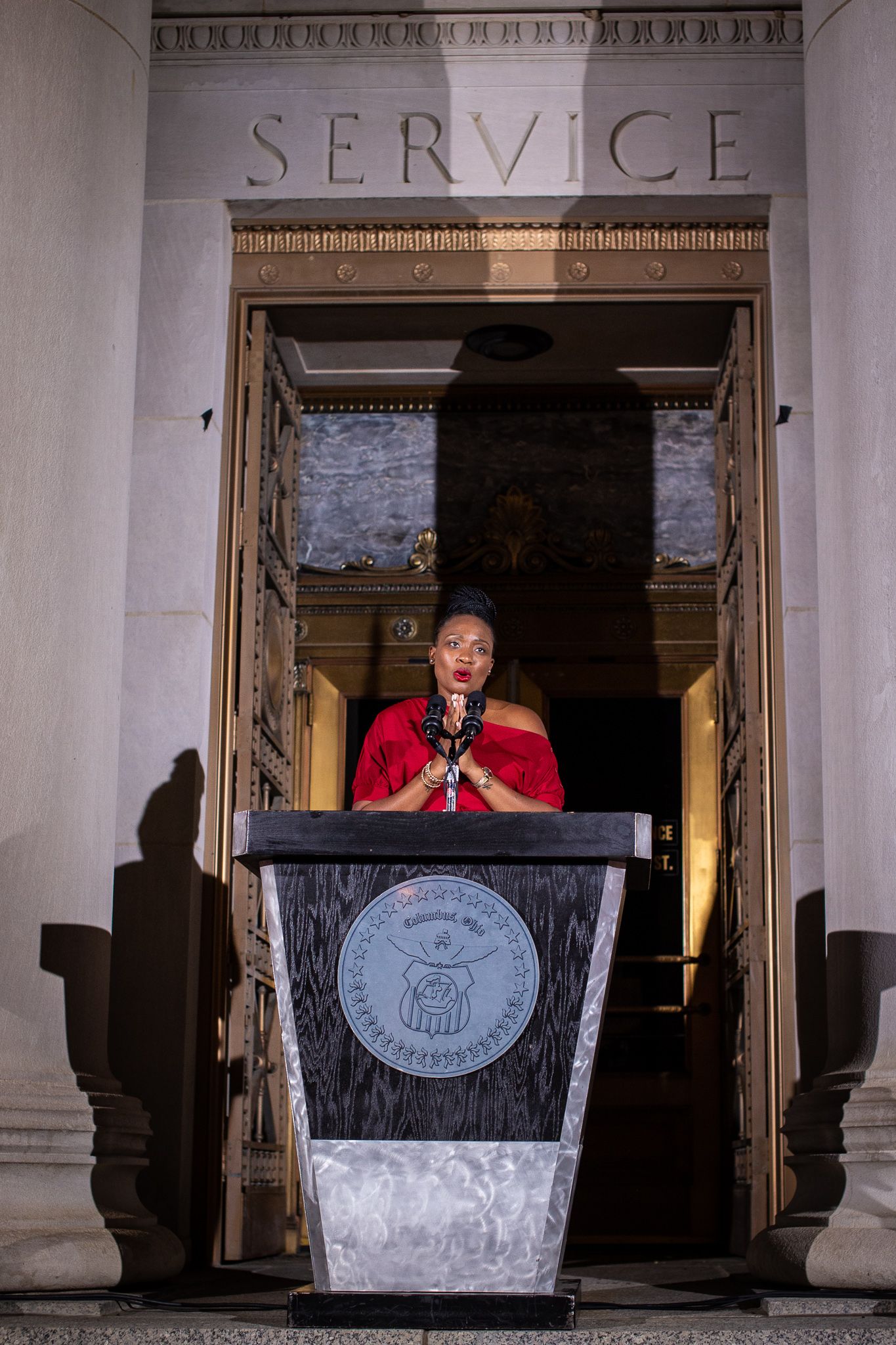 Sept. 19, 2022--Habiba Bankston speaks on the steps of Columbus City Hall during an Illumination Ceremony, bathing the civic building in red