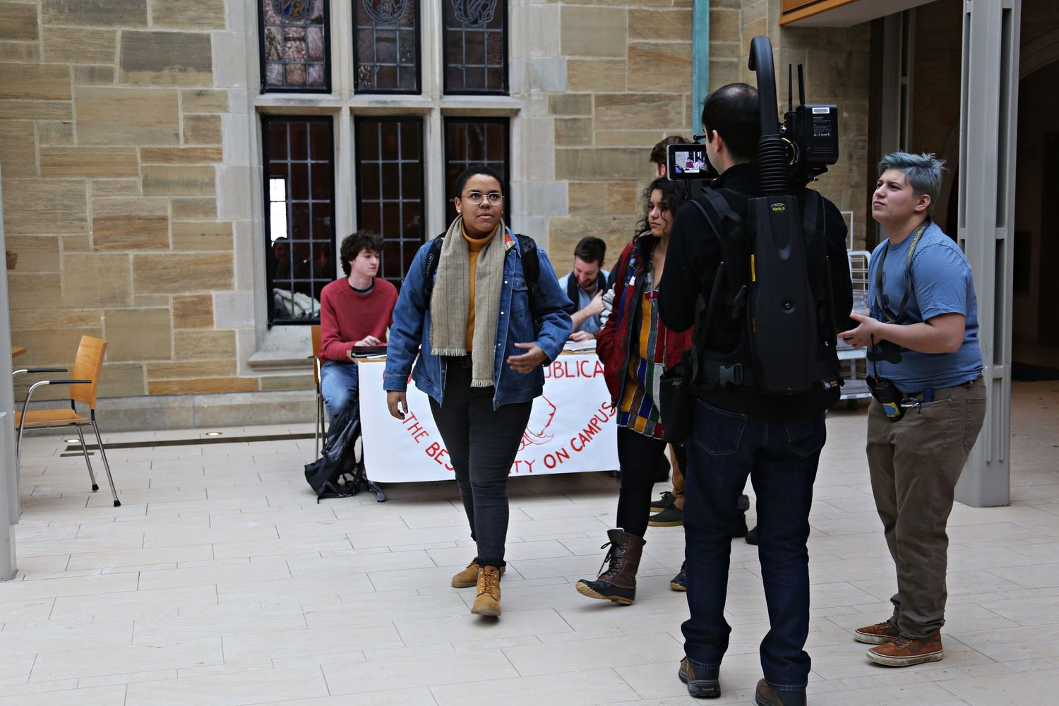 Teddy Cruz (center left) walks in front of camera crew while filming a feature length film titled…