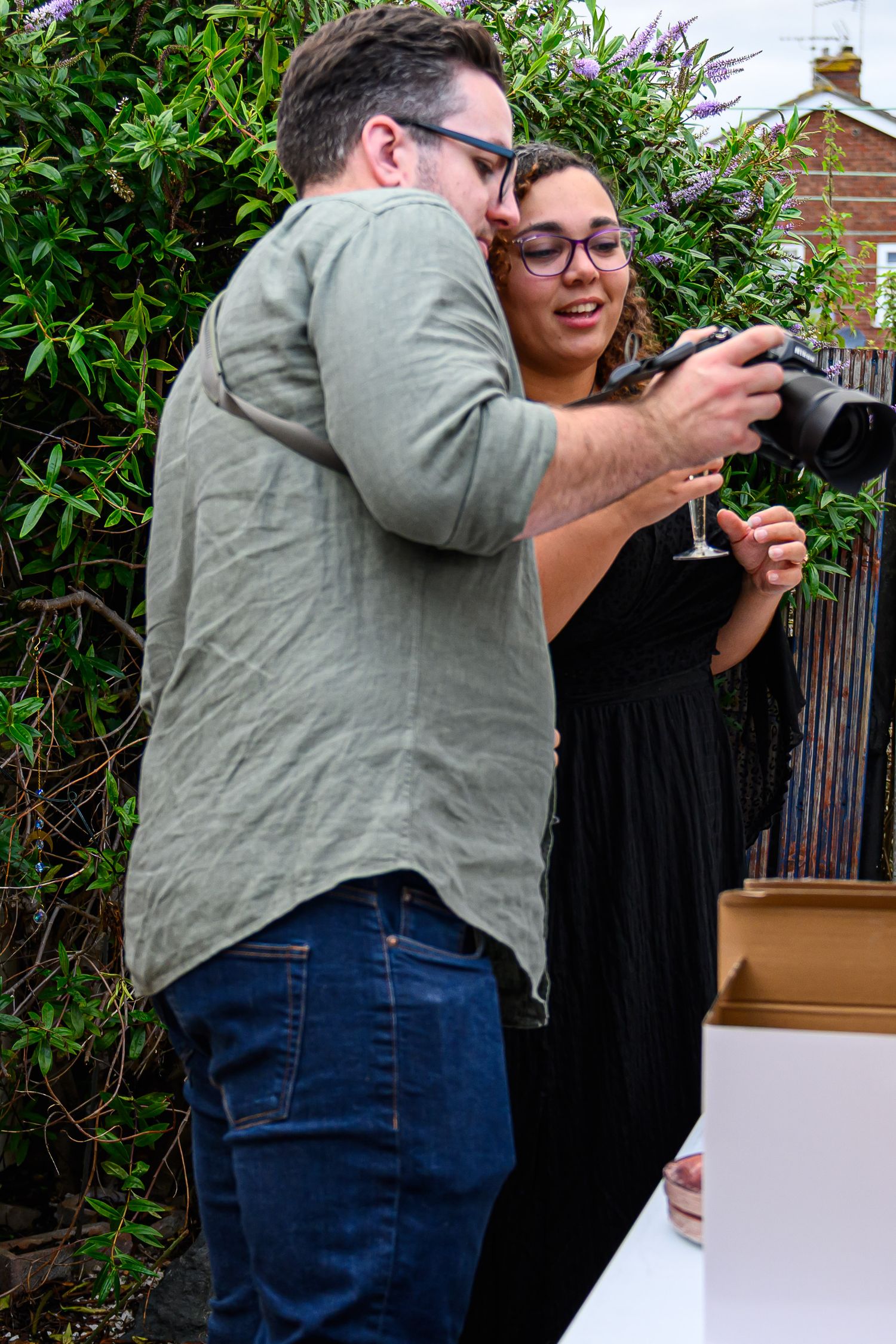 Photographers near me. Nick showing photos to the engaged couple.